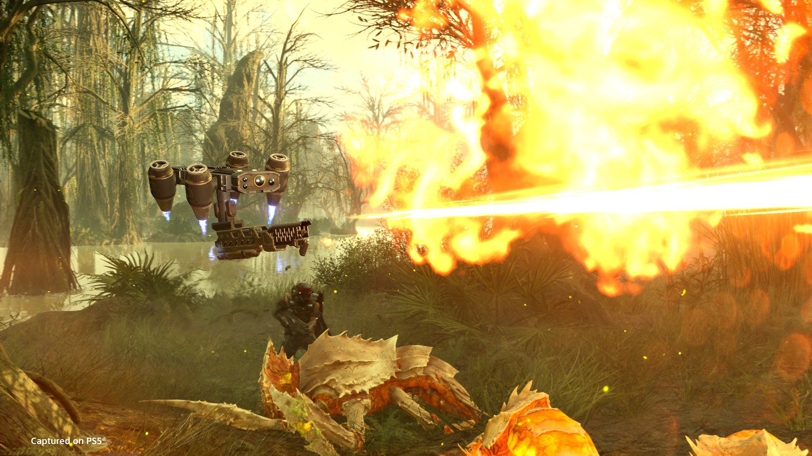 Exciting Helldivers gameplay with a flamethrower drone in action against alien creatures in a vivid jungle setting.