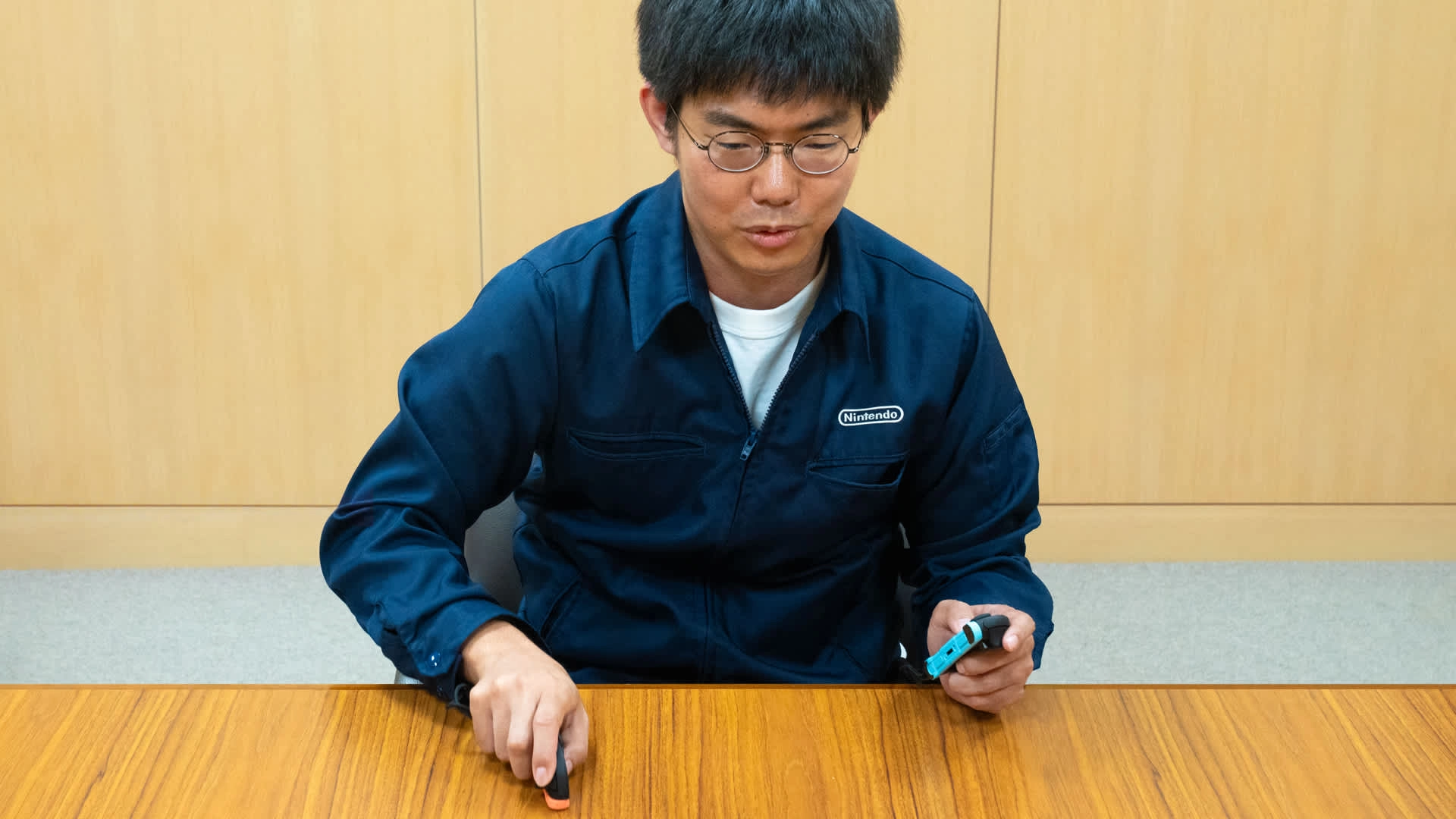 Nintendo developer discusses Drag x Drive™ during an interview, showcasing controllers and innovative game insights.