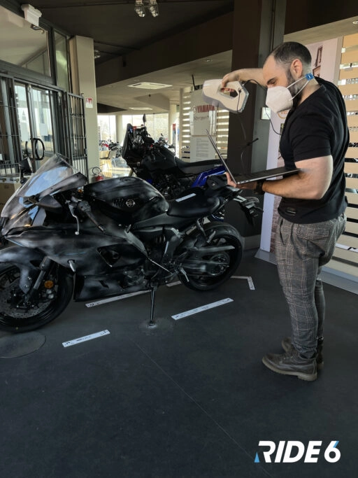 A developer scans a motorcycle for Ride 6, showcasing the meticulous detail in 3D modeling for realistic gameplay.