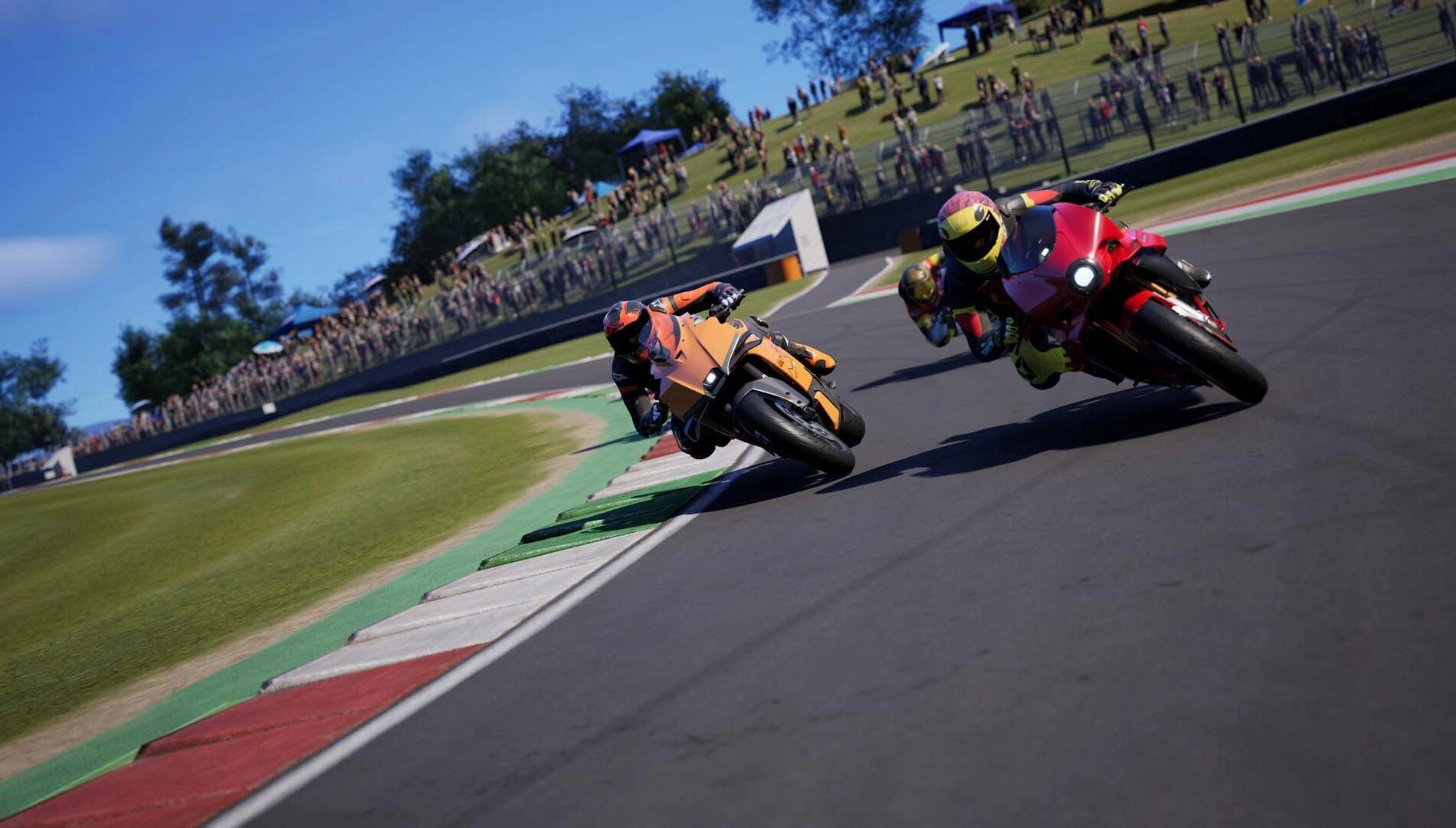 Two motorcycles racing on a track with a blurred crowd in the background, showcasing the thrill of Ride 6 gameplay.