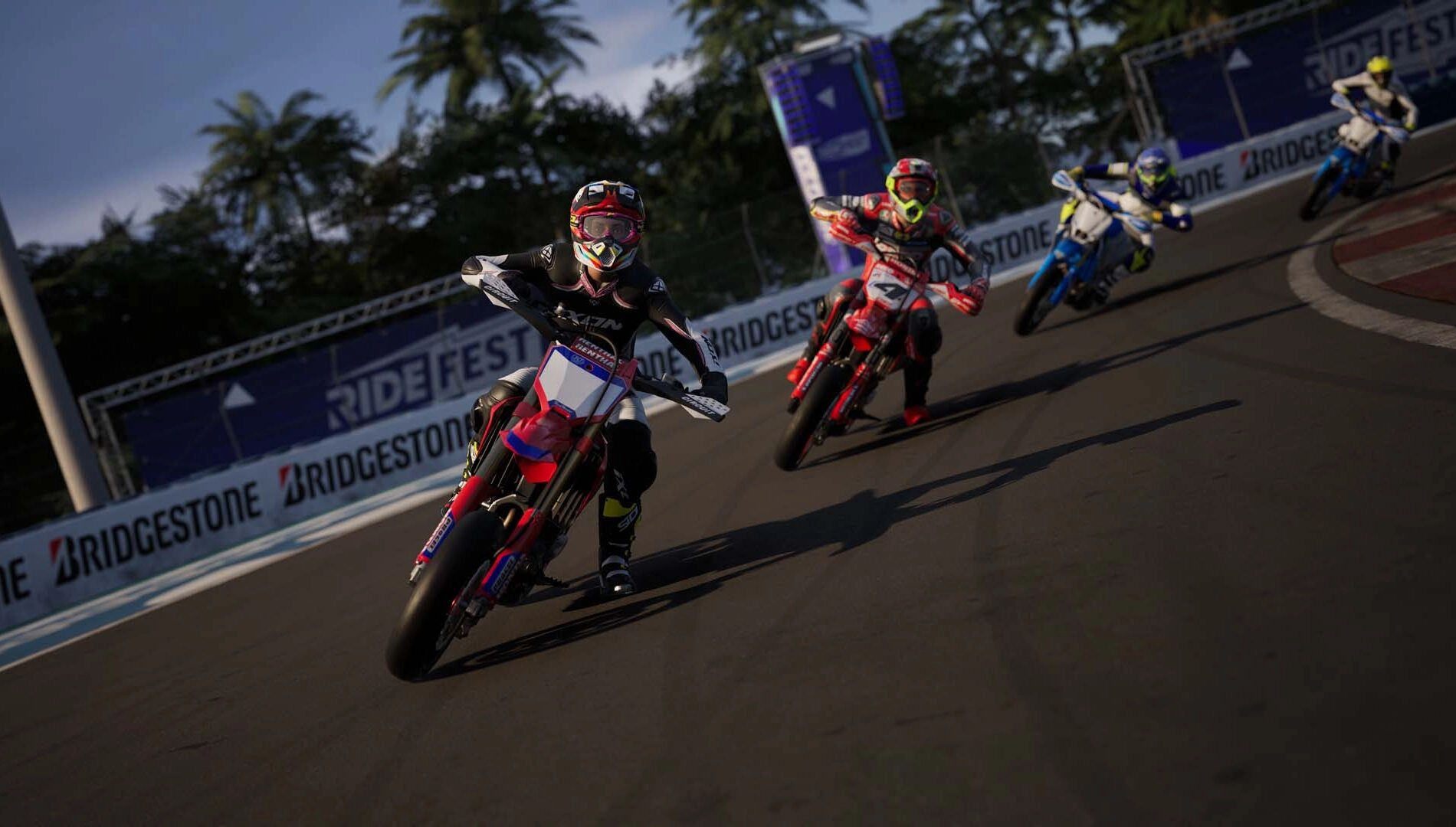 Four motorcyclists racing on a track in Ride 6, showcasing detailed bikes in a vibrant, competitive environment.