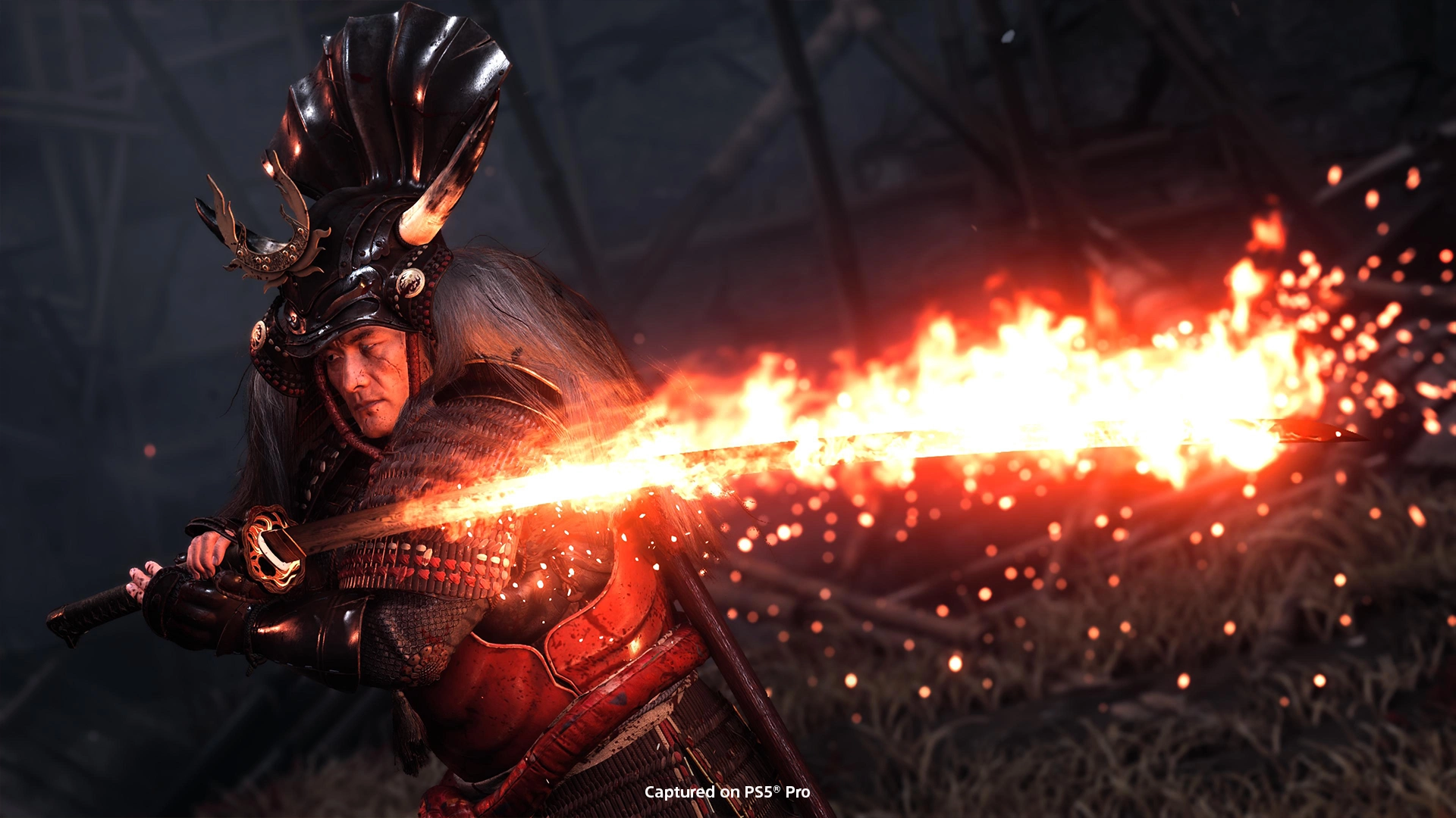 A fierce samurai in ornate armor wields a flaming sword, embodying the intense climax of Ghost of Yōtei’s Ezo adventure.