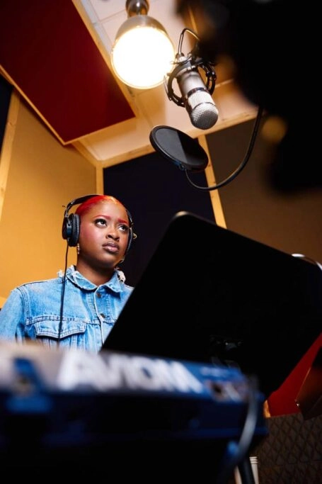 Ella Mental, a new character from Invincible VS, recorded her voice in a studio, showcasing her dynamic persona.