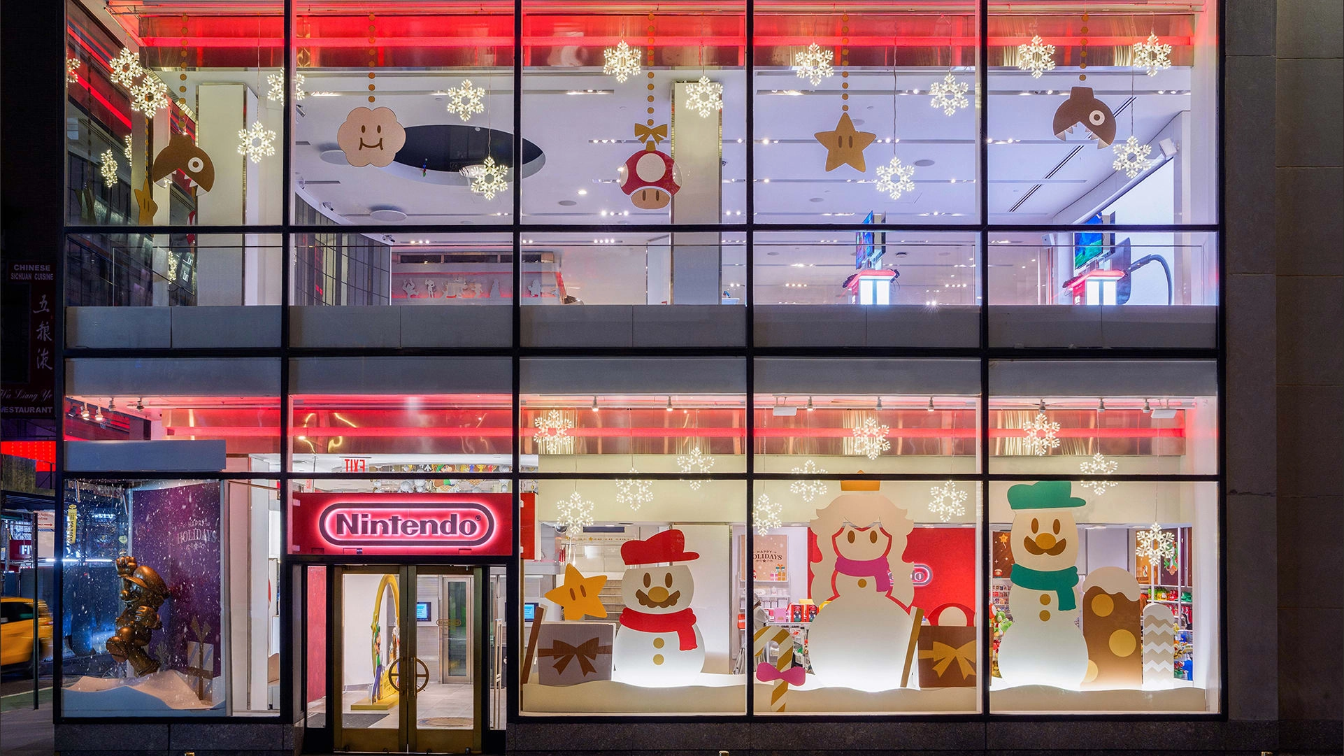 Holiday window display at Nintendo Store, showcasing festive decorations and exclusive merchandise for the winter season.