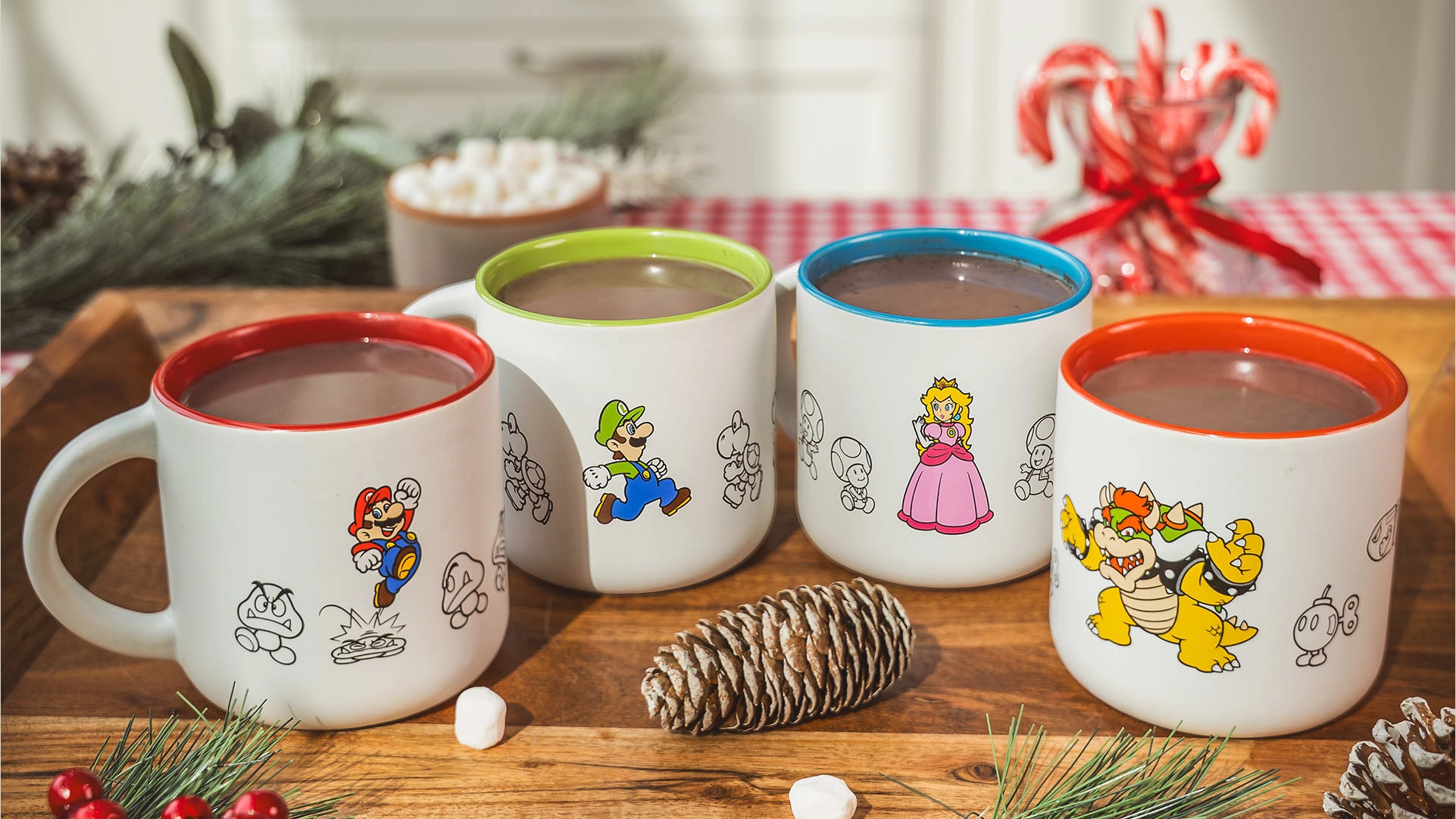 Cozy Nintendo holiday mugs featuring Mario, Luigi, Peach, and Bowser, perfect for hot cocoa this season.