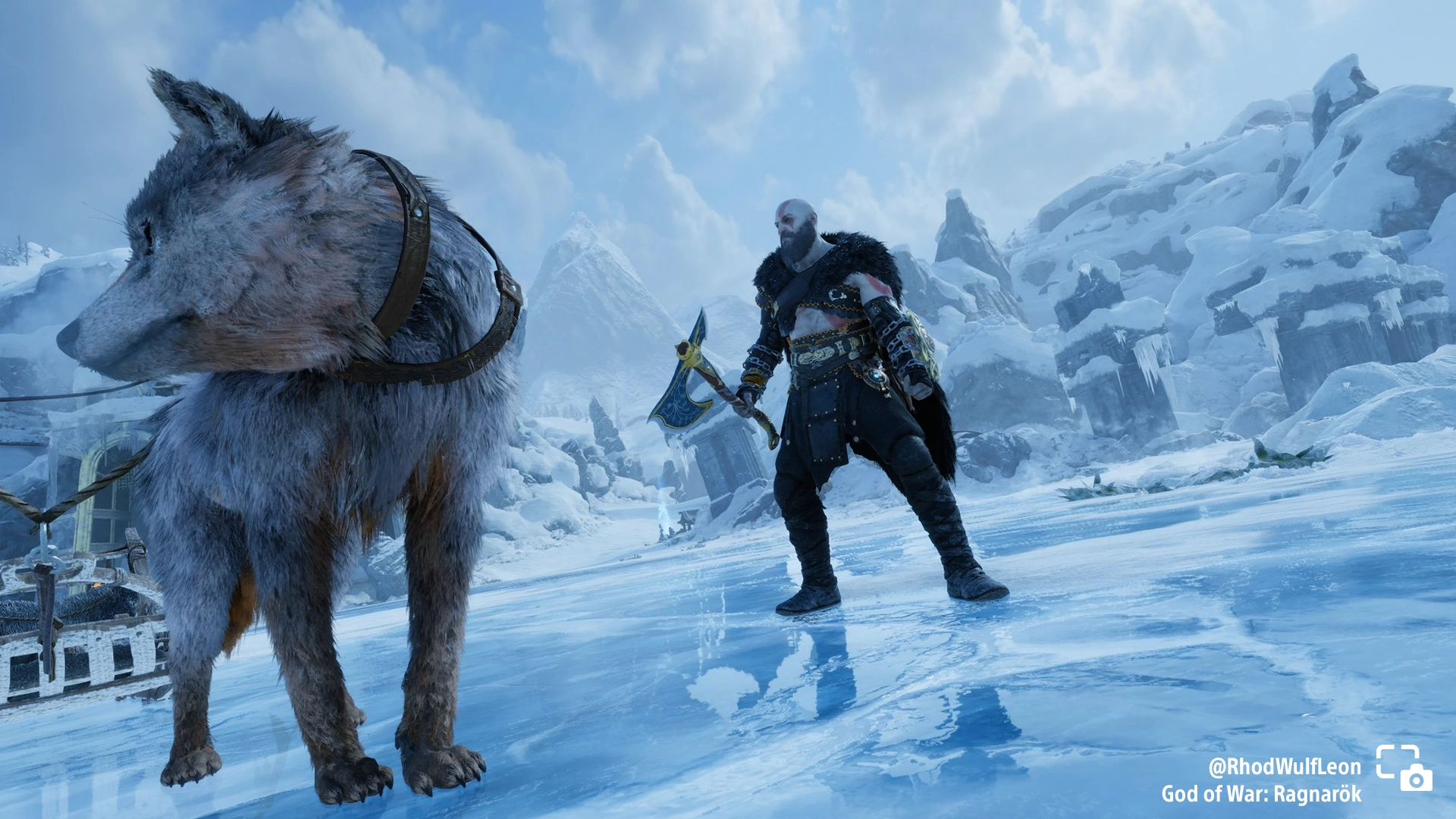 Kratos stands on icy terrain with a wolf companion in God of War Ragnarök, showcasing a stunning snowy landscape.