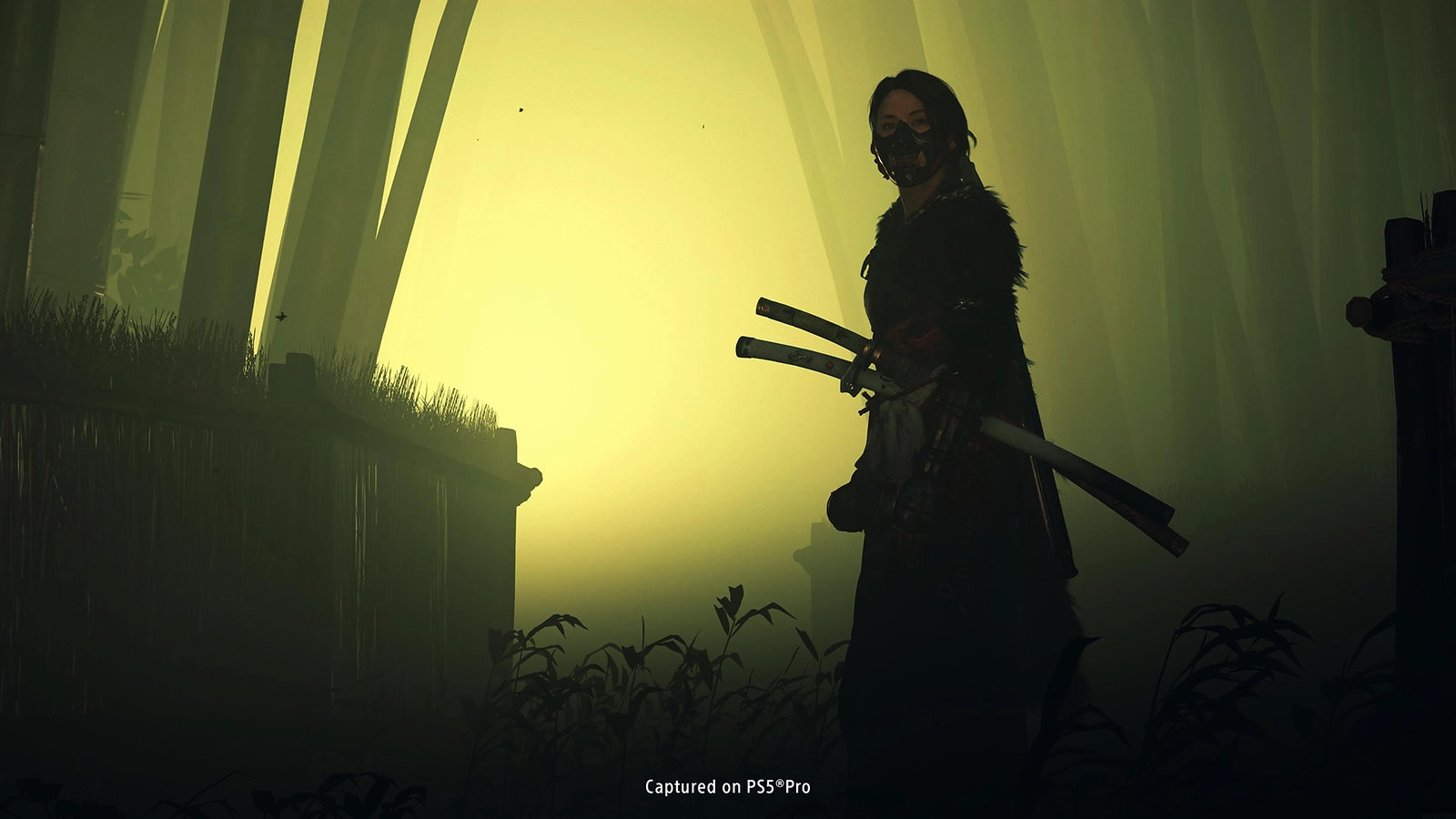 A mysterious figure holding two swords stands before looming doors, hinting at the spooky quest in Ghost of Yōtei.