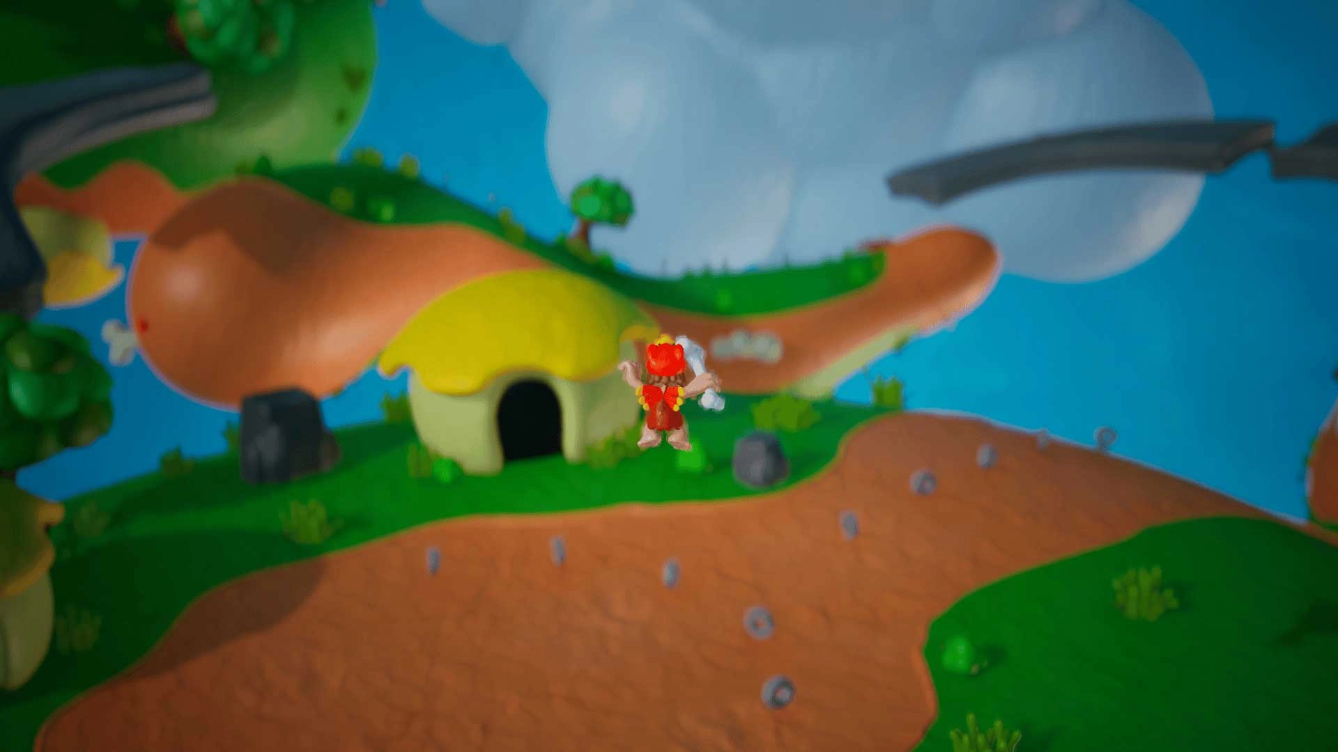 Caveman character jumping on a colorful, play-dough-style planet with a yellow-roofed cave nearby
