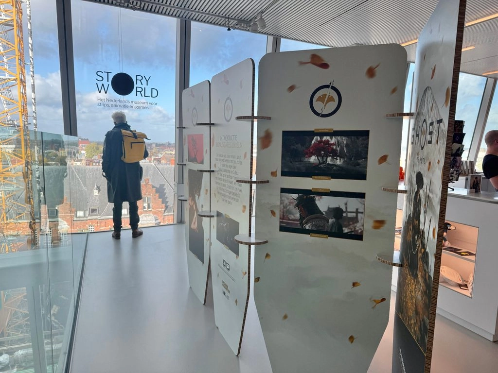 Exhibition panels showcasing Ghost of Yōtei artwork and information at a modern museum setting