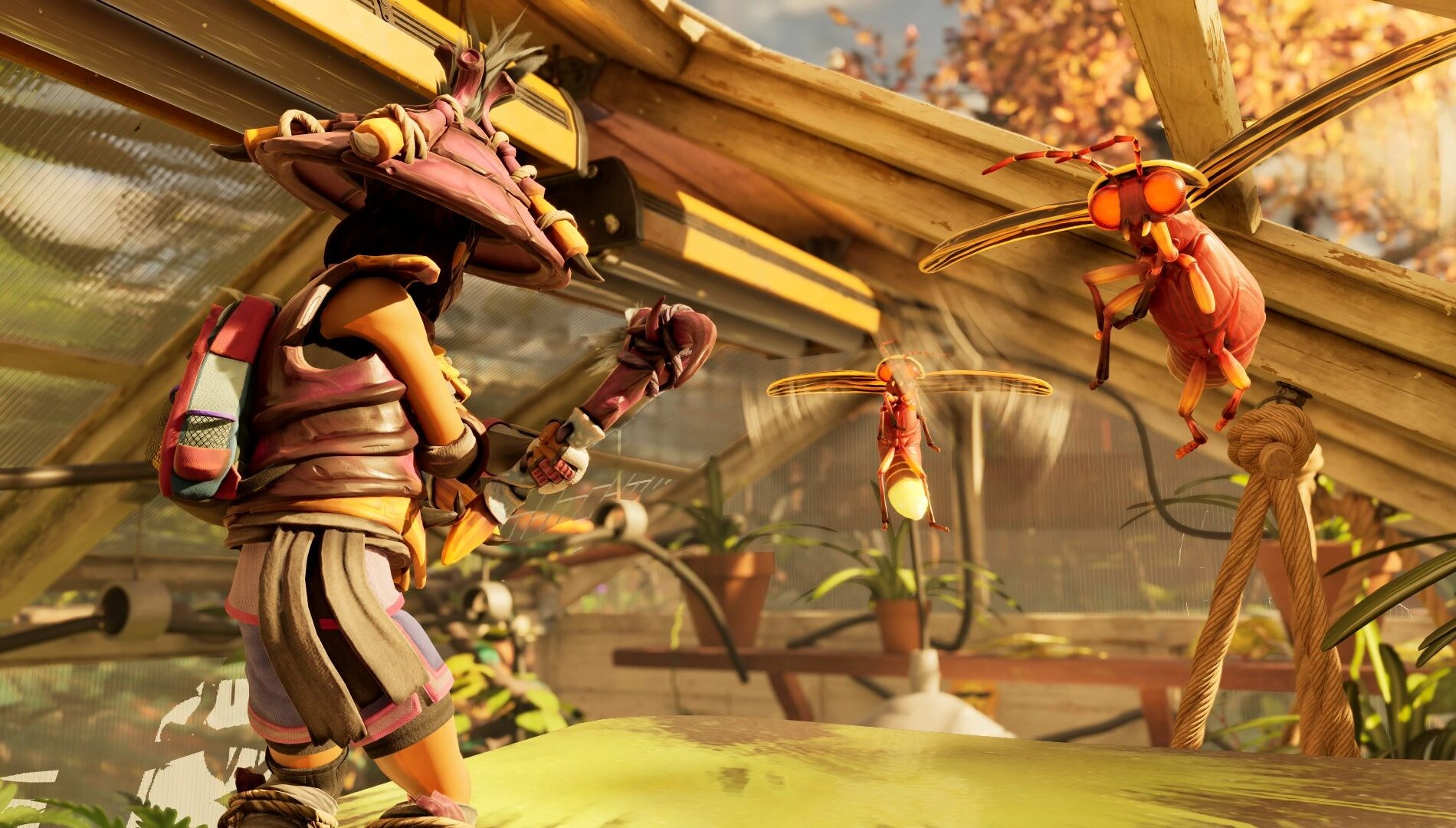 A character in armor battles large insects in a greenhouse, showcasing the new Garden biome in Grounded 2