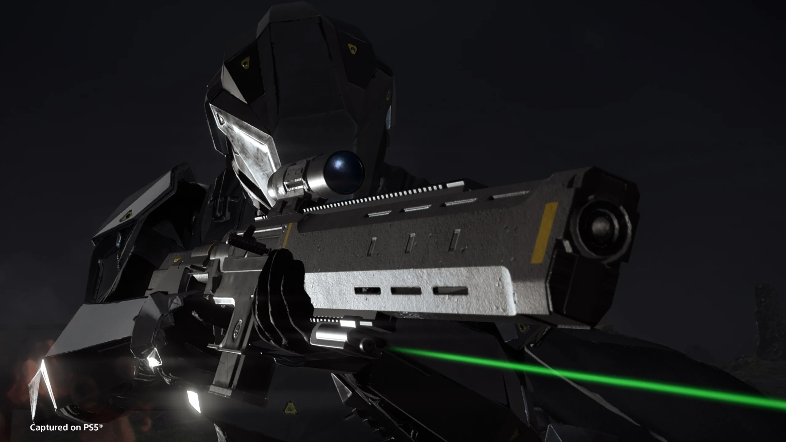 Stealthy soldier in futuristic gear aims precision rifle with green laser sight in dark setting.
