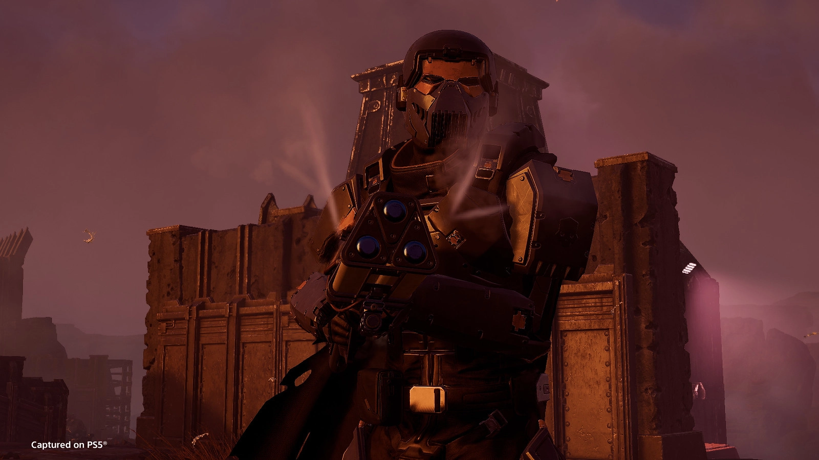 A heavily armored soldier stands ready with a futuristic weapon, surrounded by a fortified structure