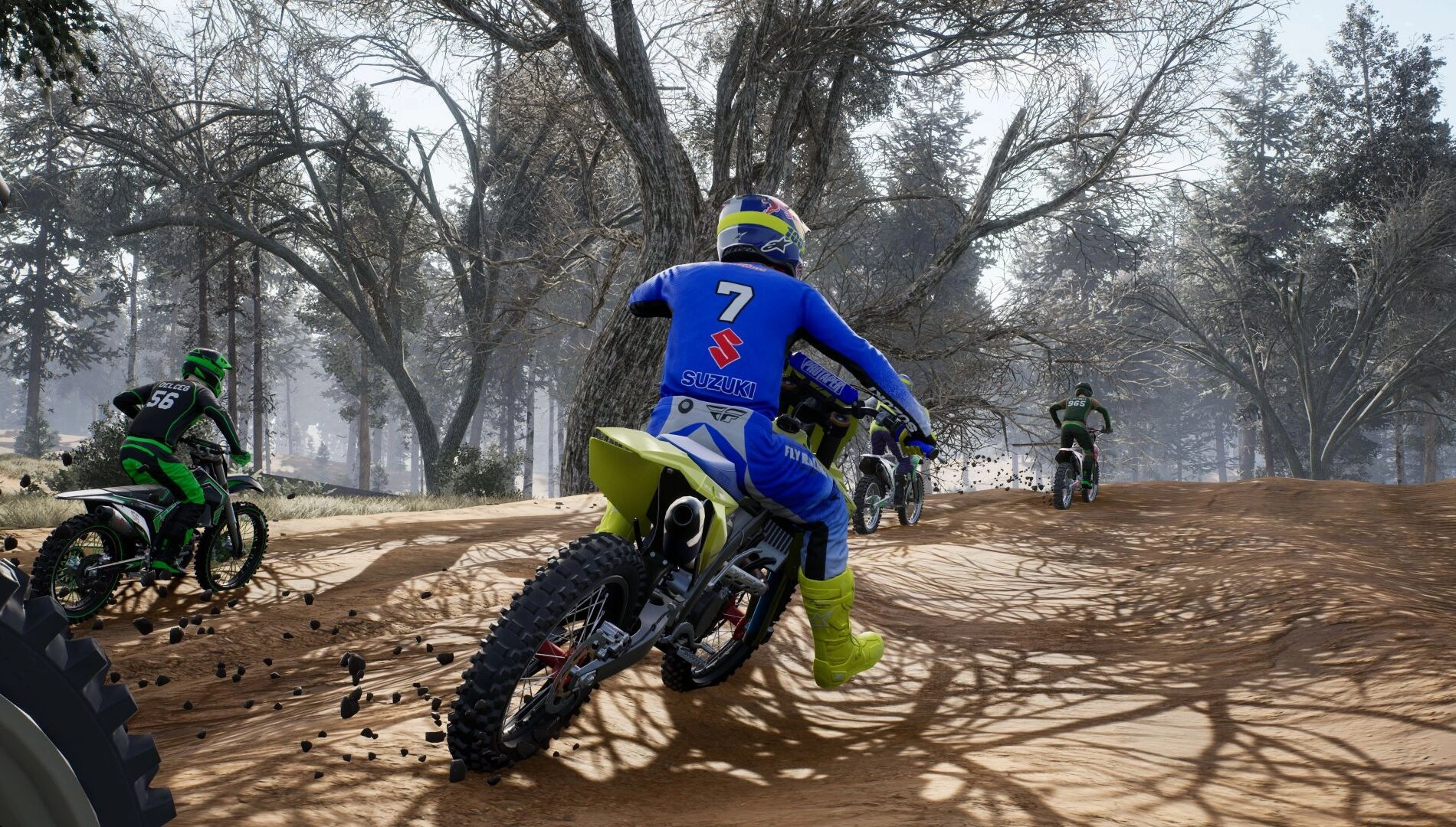 Motorcyclists racing on a dirt track through a forest, showcasing thrilling off-road action and speed