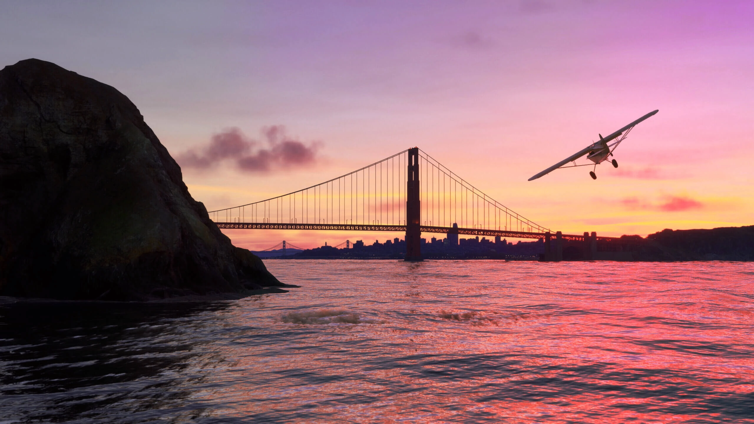 A small plane flies over San Francisco Bay at sunset, with the Golden Gate Bridge silhouetted in the background