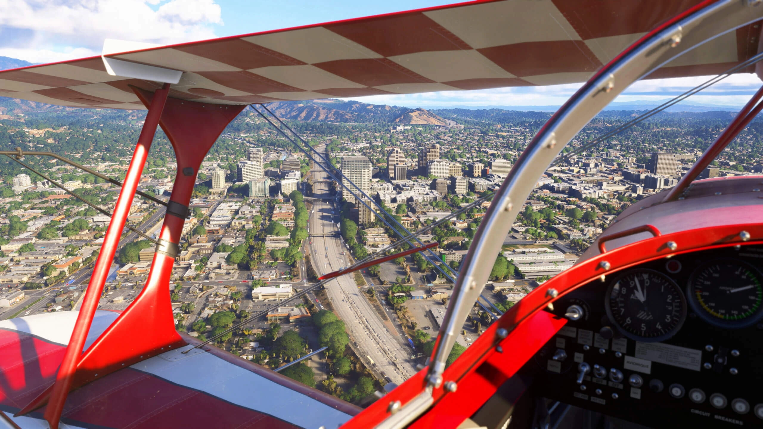 A vibrant aerial view of Sacramento, showcasing detailed cityscape and lush surroundings from a red biplane