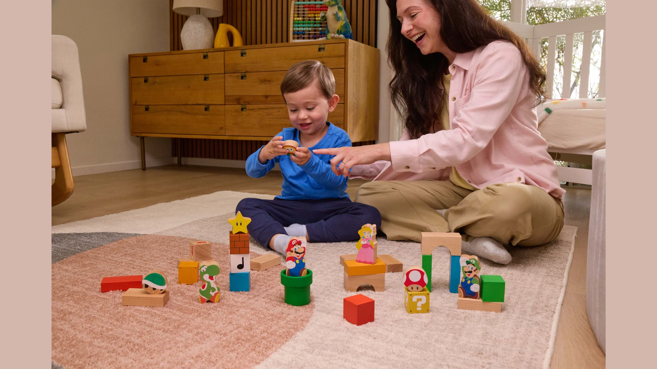 Mom and child play together with colorful My Mario wooden blocks, fostering creativity and fun in a cozy setting.