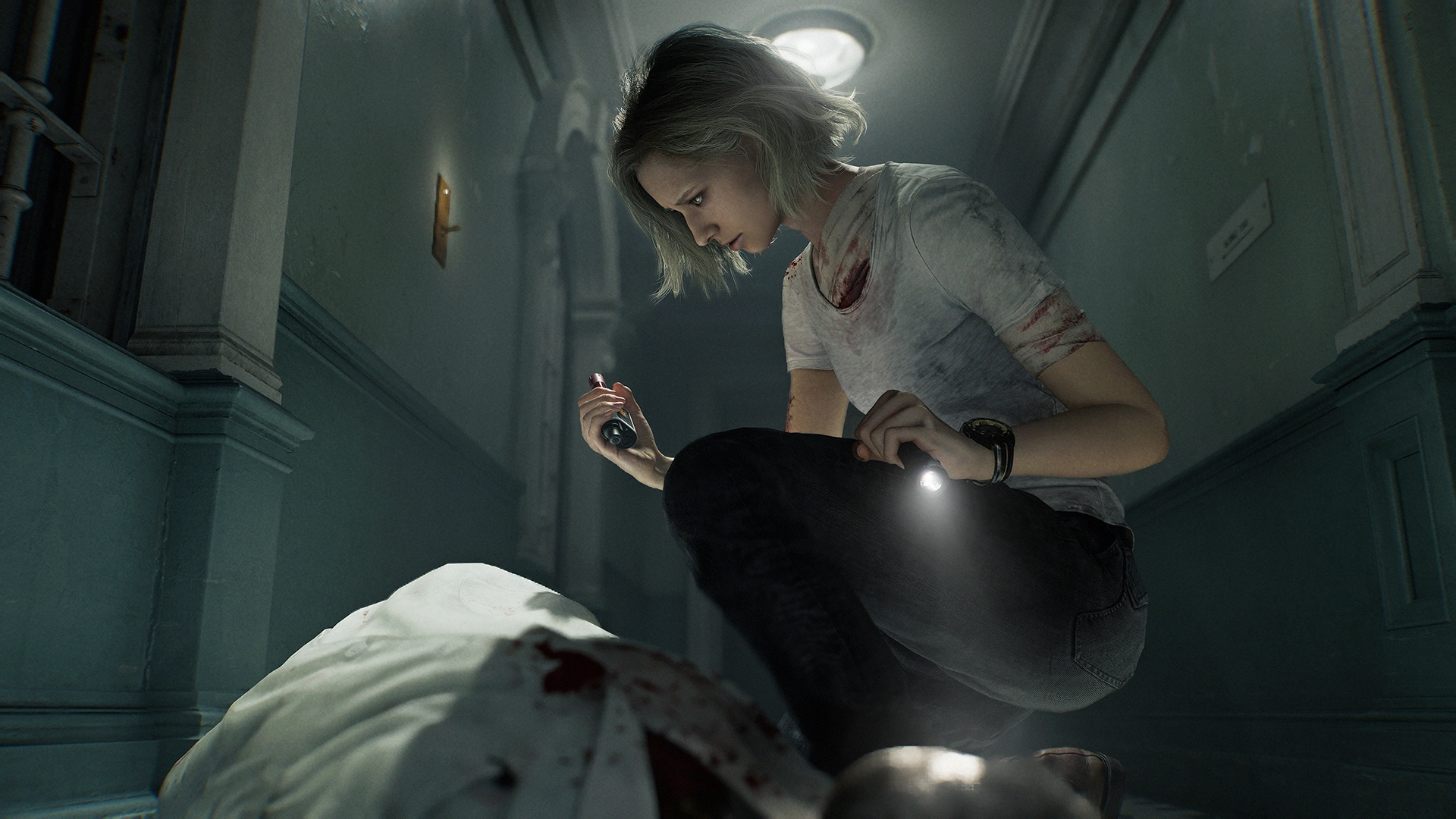 A woman with a flashlight examines a bloodied body in a dimly lit hallway, evoking a tense atmosphere