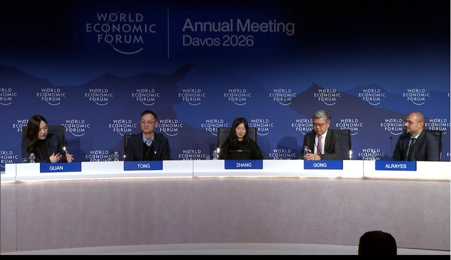 Panel discussion at World Economic Forum 2026, featuring speakers on AI's diverse applications and impact