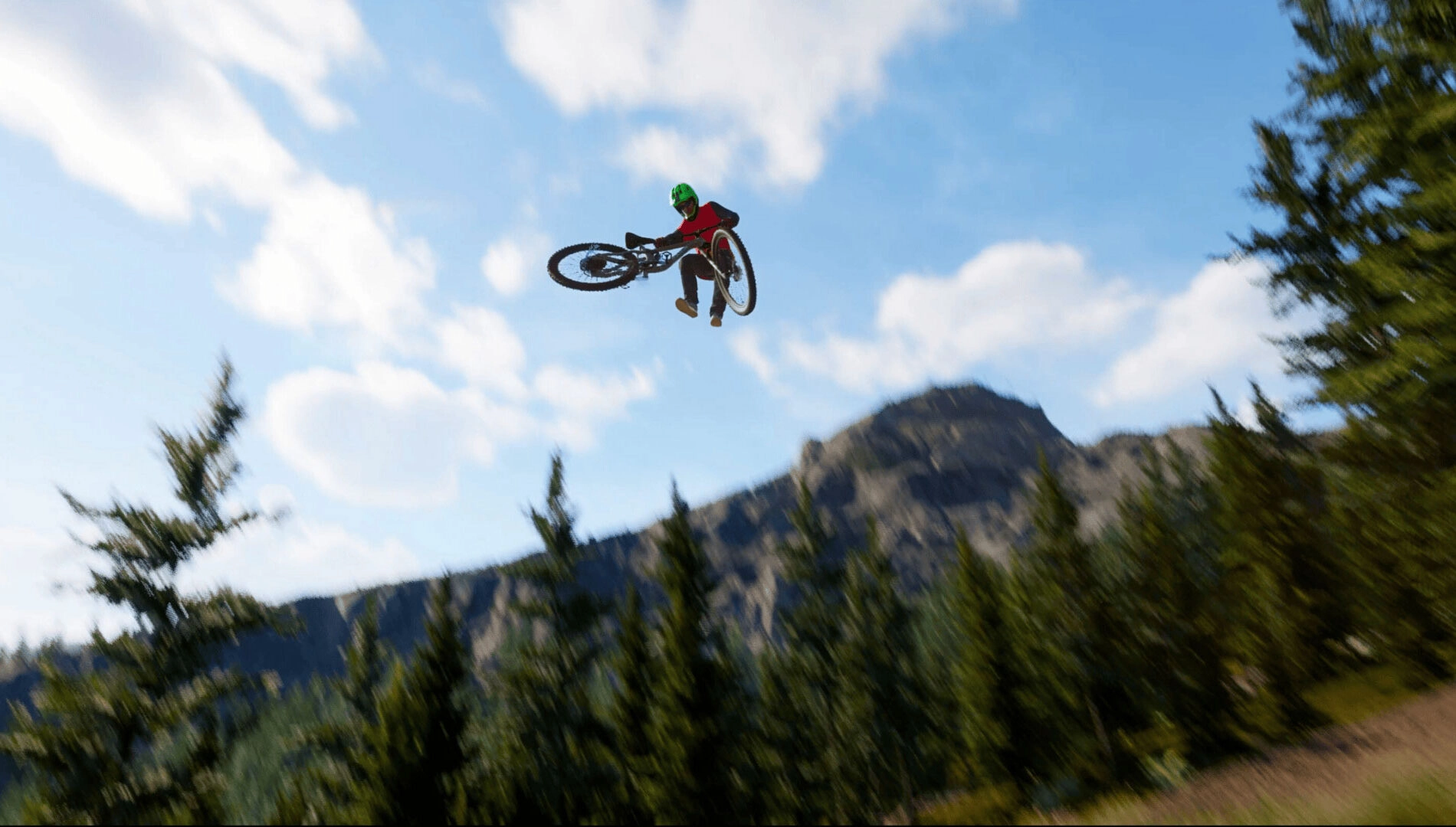 Mountain biker performing a high jump against a scenic backdrop of trees and mountains in a video game