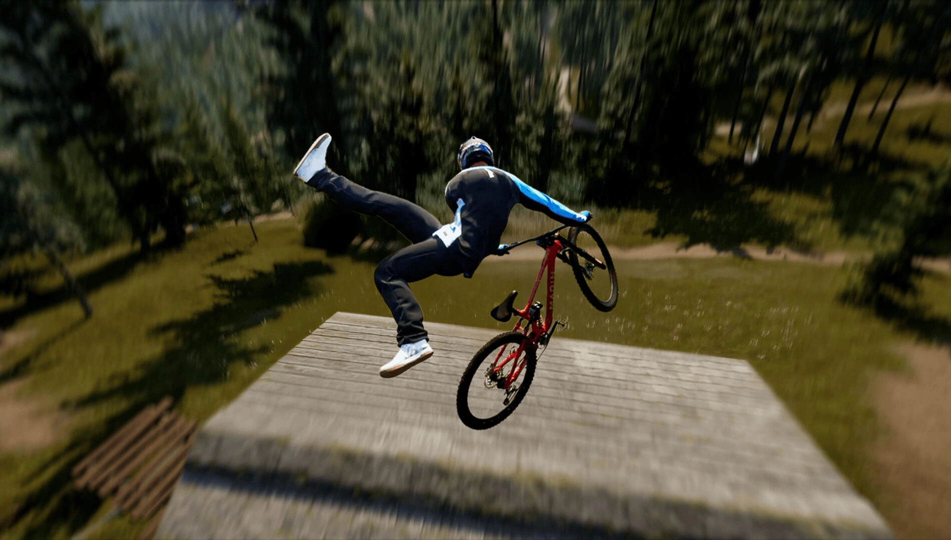 Mountain biker performs a trick mid-air on a red bike, showcasing dynamic movement in a forest setting