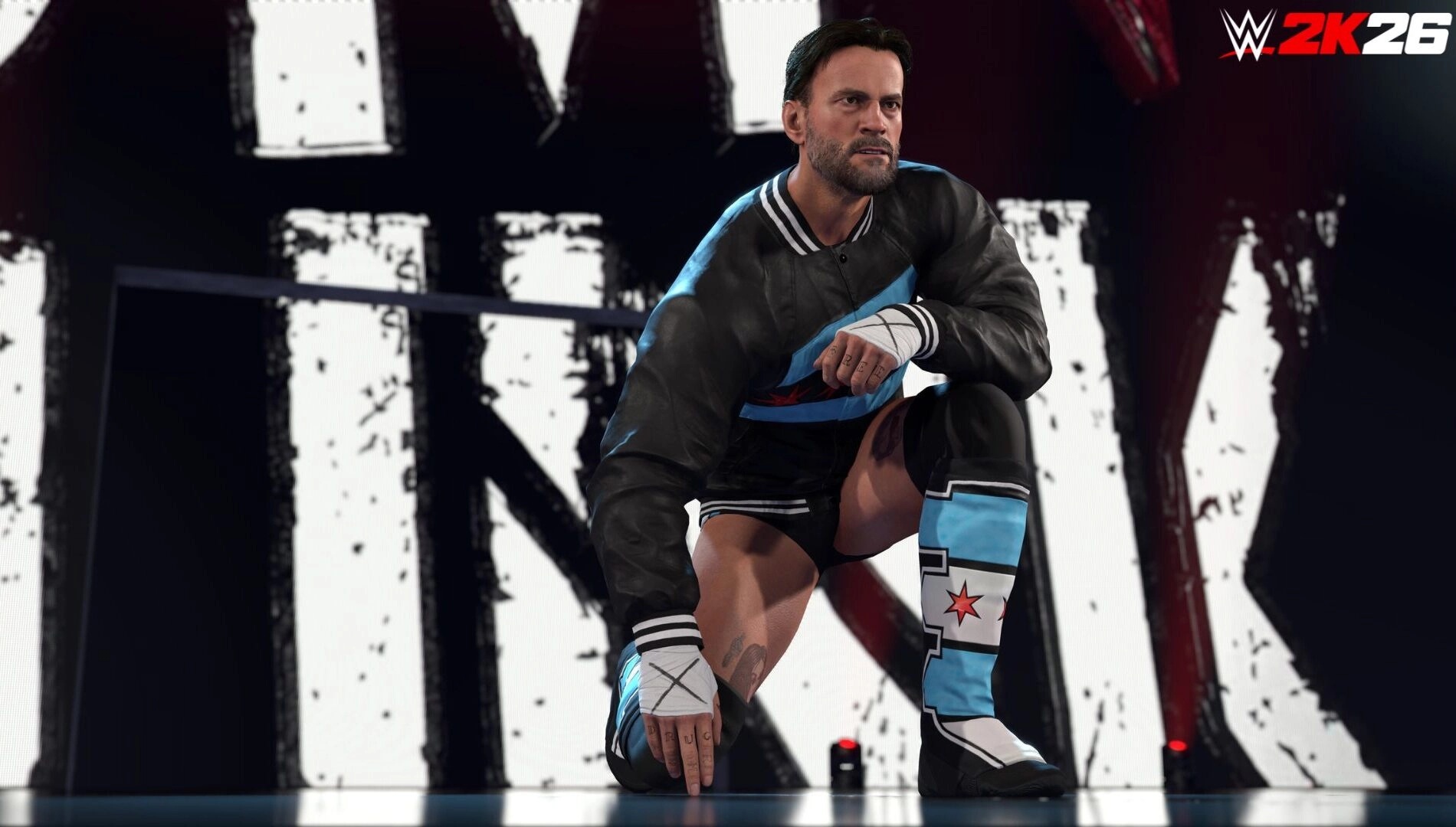 CM Punk kneels in a wrestling ring wearing a black jacket and blue gear, WWE 2K26 logo in the background