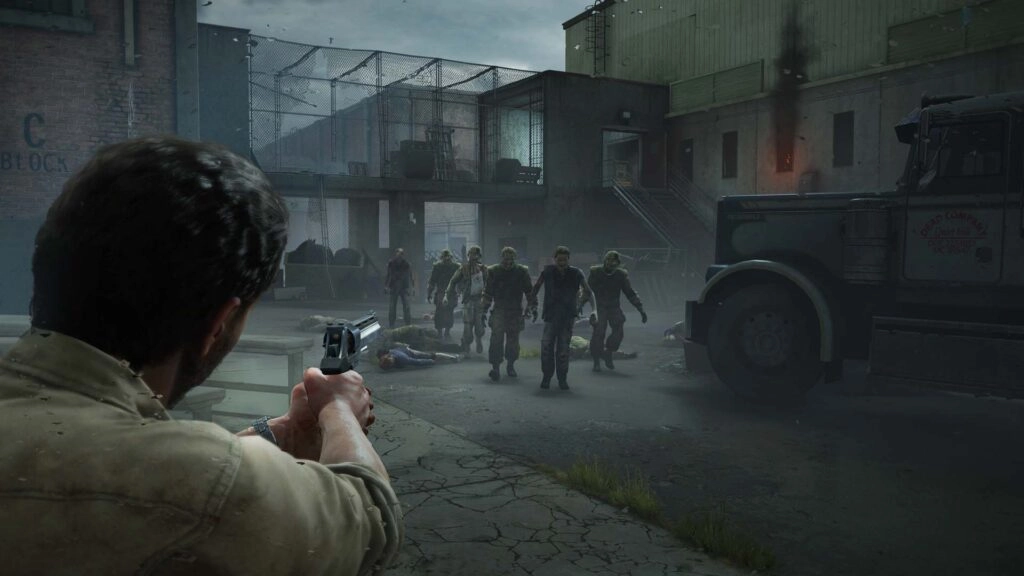 A survivor aims a handgun at approaching zombies in an industrial setting, creating a tense atmosphere
