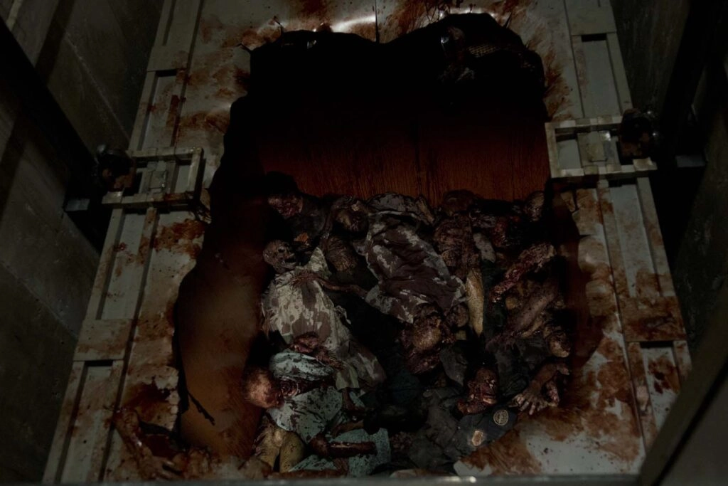 A pit filled with decaying zombie bodies, limbs scattered, creating a gruesome and chilling atmosphere