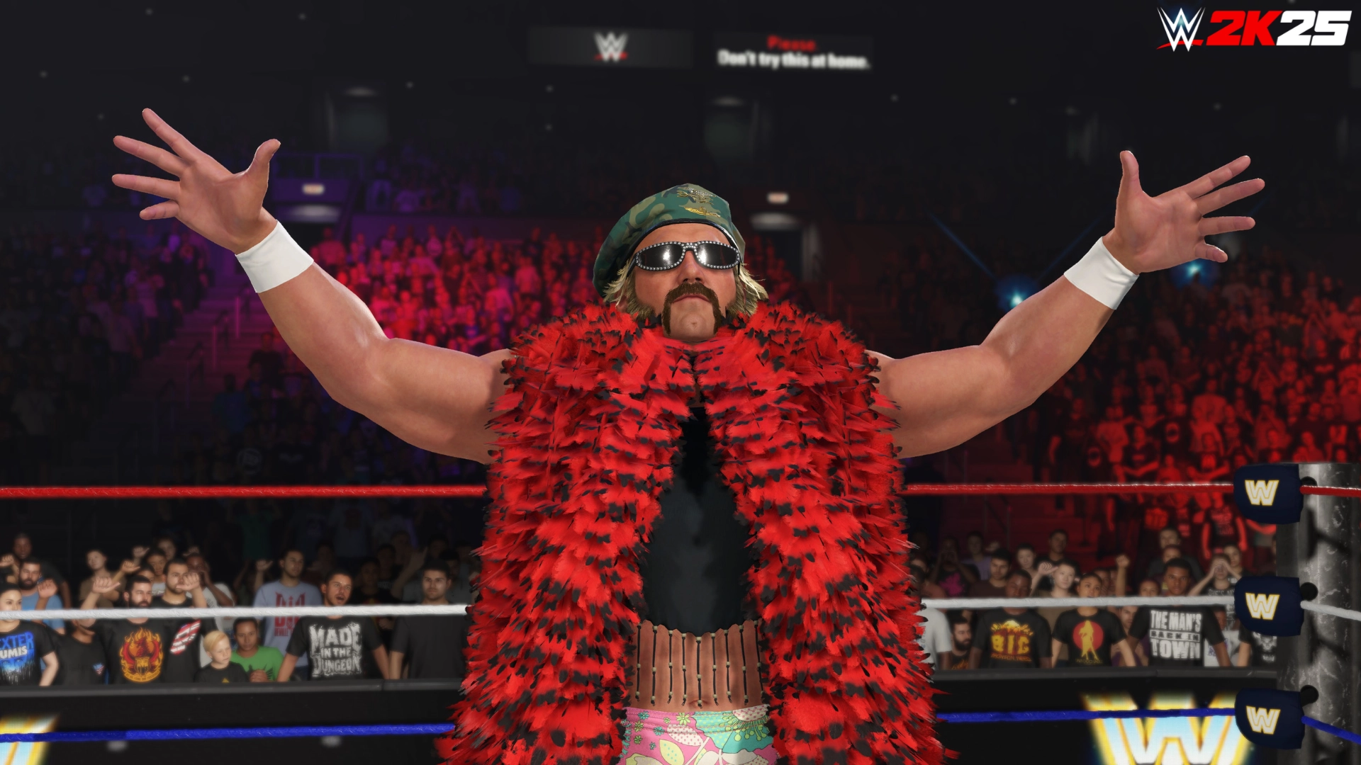 Wrestler in red feathered boa and sunglasses poses in WWE 2K25 ring, embodying golden era charisma