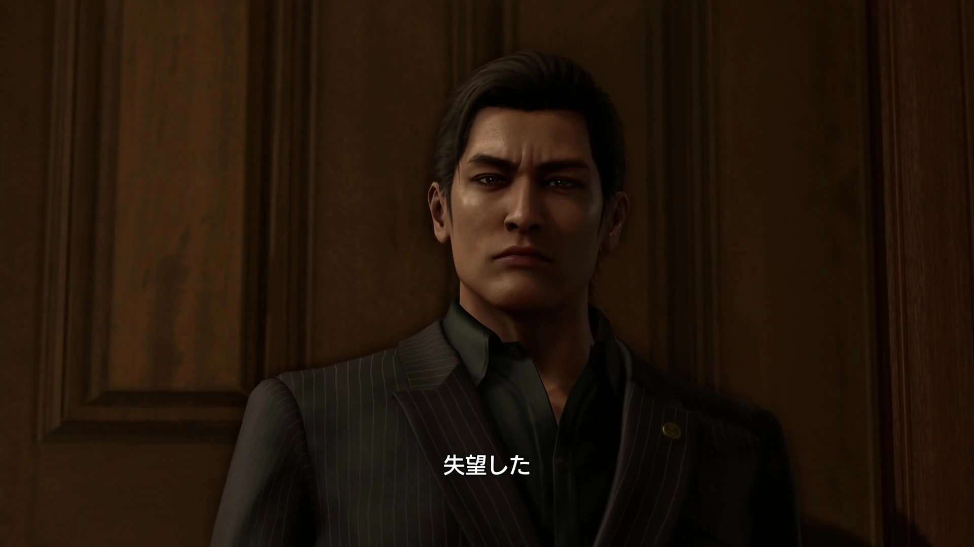 A serious man in a dark suit stands against a wooden background, conveying a tense atmosphere