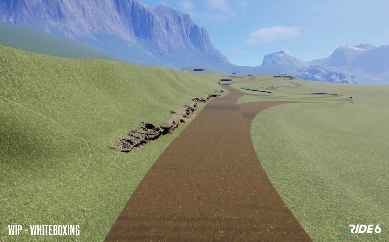 Aerial view of a Ride 6 game track in development, showcasing terrain and early design elements