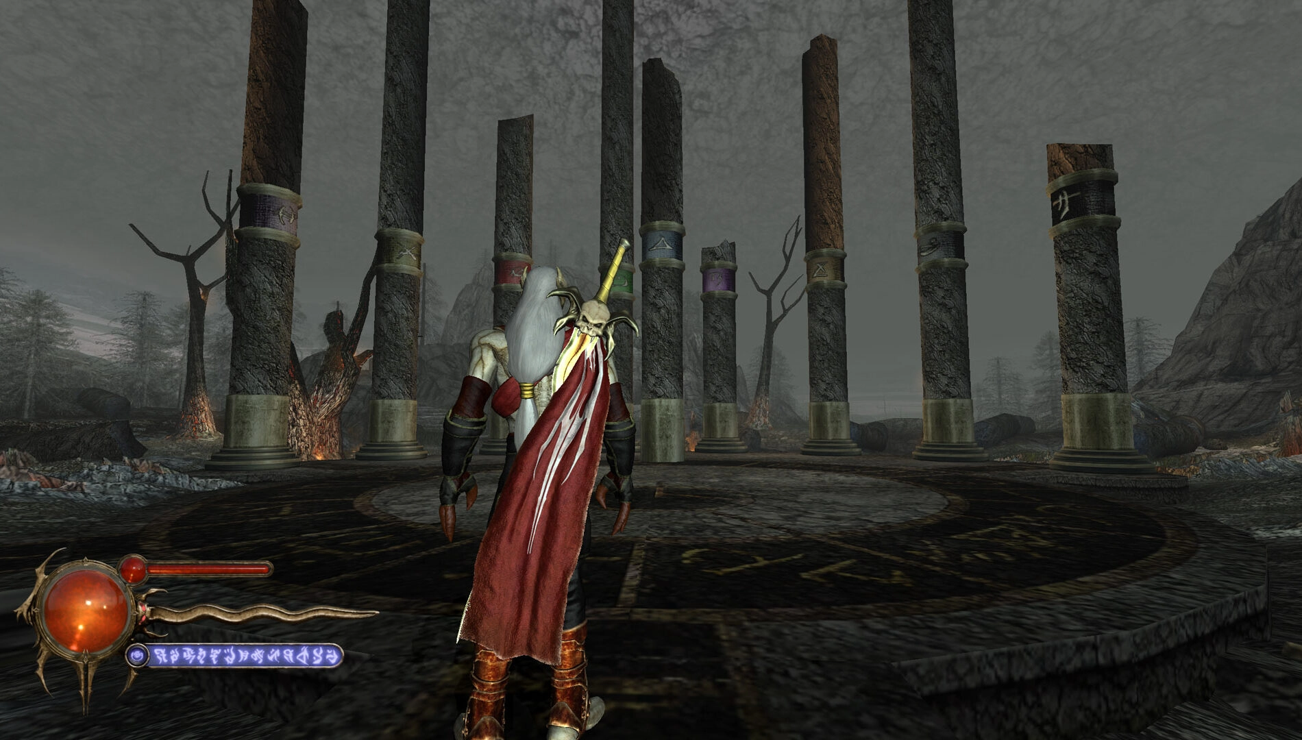 A character in a red cloak stands before ancient stone pillars in a dark fantasy landscape from Legacy of Kain