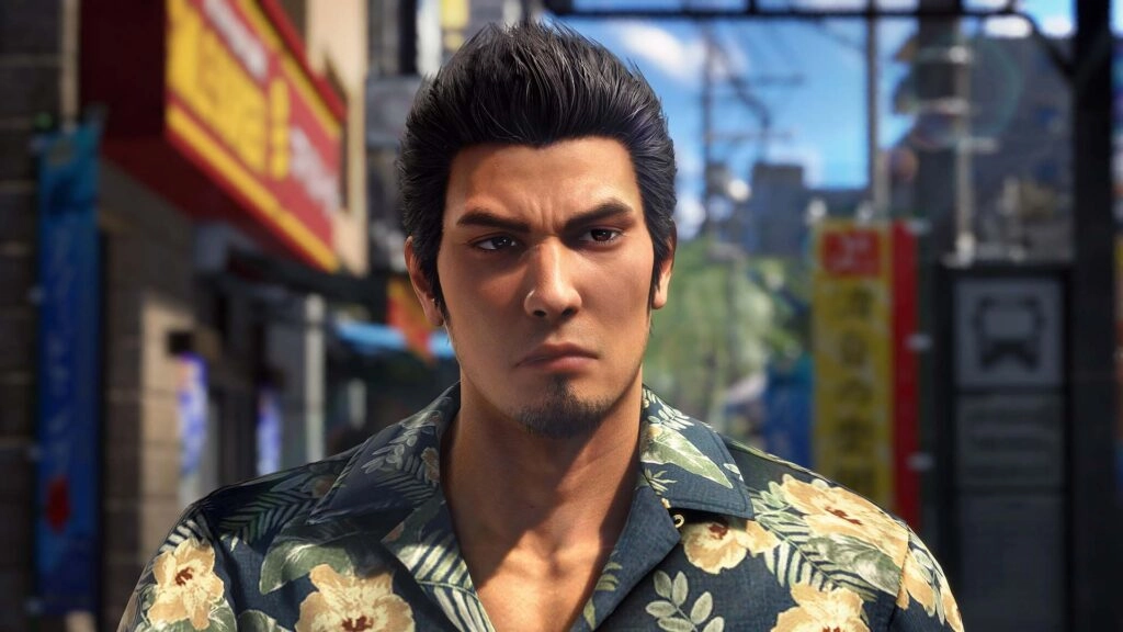 Kiryu stands in a bustling Japanese street, wearing a floral shirt, embodying a strong and determined presence