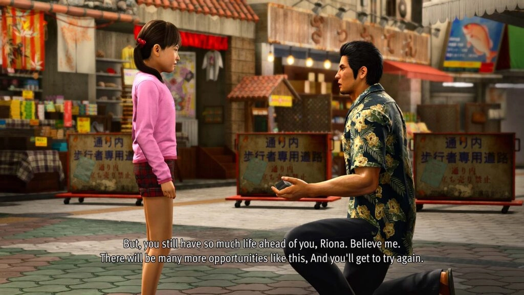 Kiryu kneels, encouraging a young girl in a lively market setting, emphasizing support and guidance