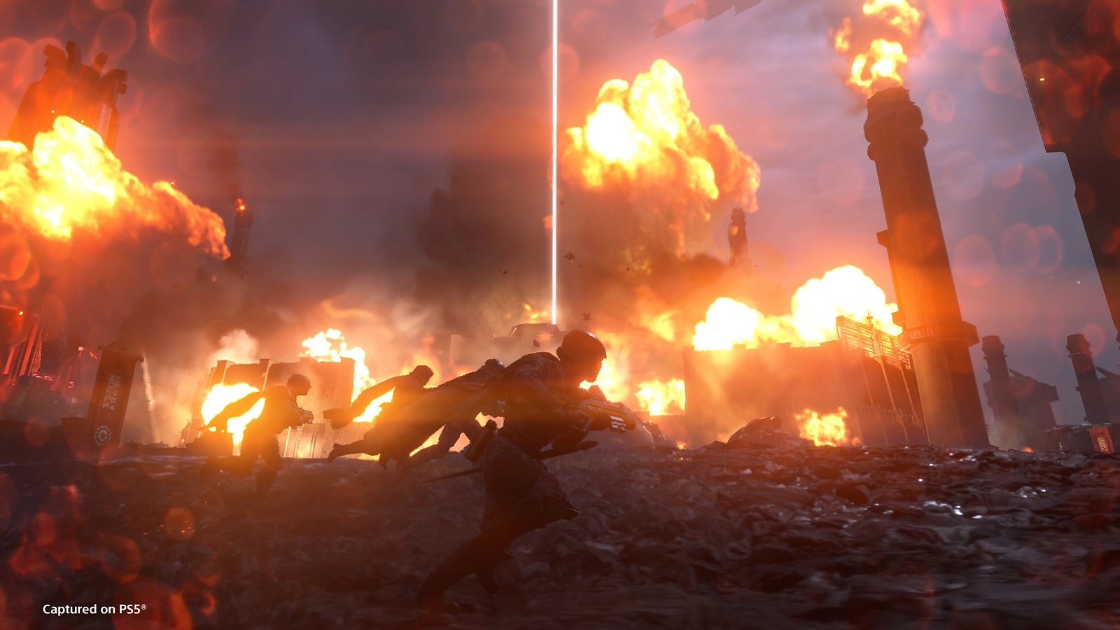 Cyborgs and Helldivers clash in fiery battle amidst burning factory cityscape in Cyberstan's dark streets