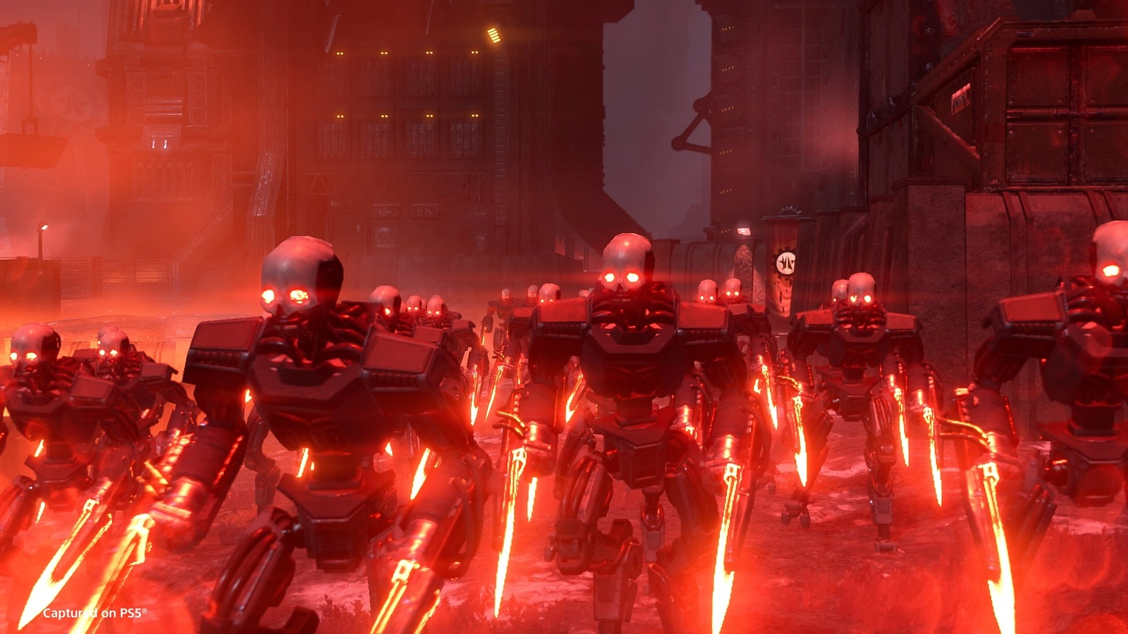 Cyborgs with glowing red eyes and weapons march through a dark, industrial cityscape in Cyberstan
