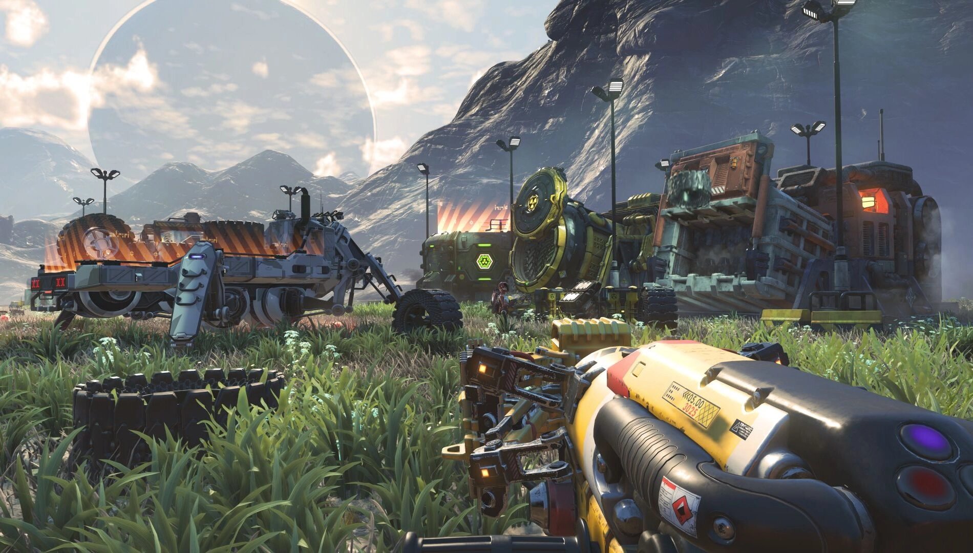 A player in No Man's Sky aims a Gravitino Coil at futuristic vehicles and machinery on a grassy planet