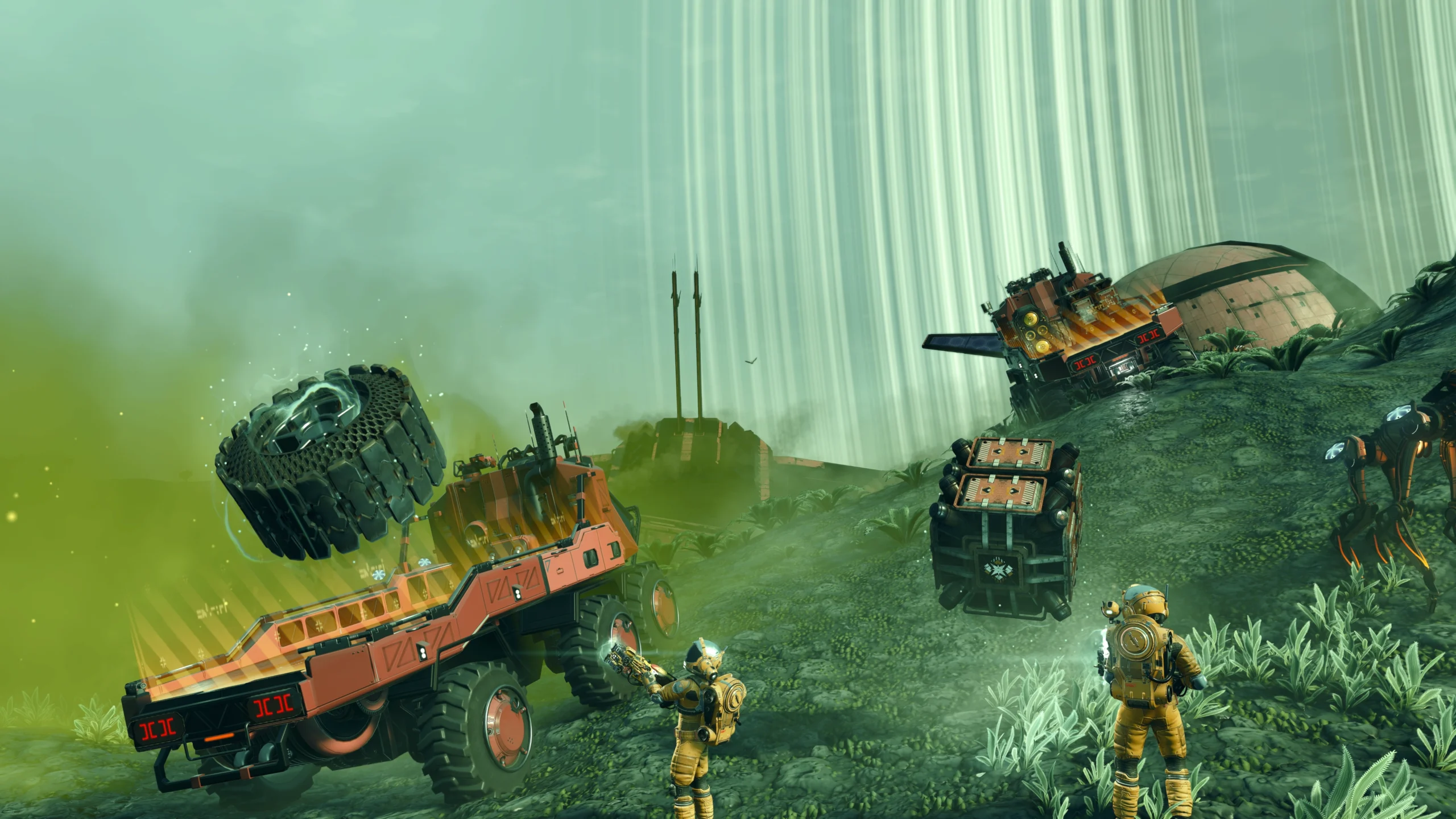 Players using gravity gun to lift debris near futuristic trucks on an alien landscape in No Man’s Sky update