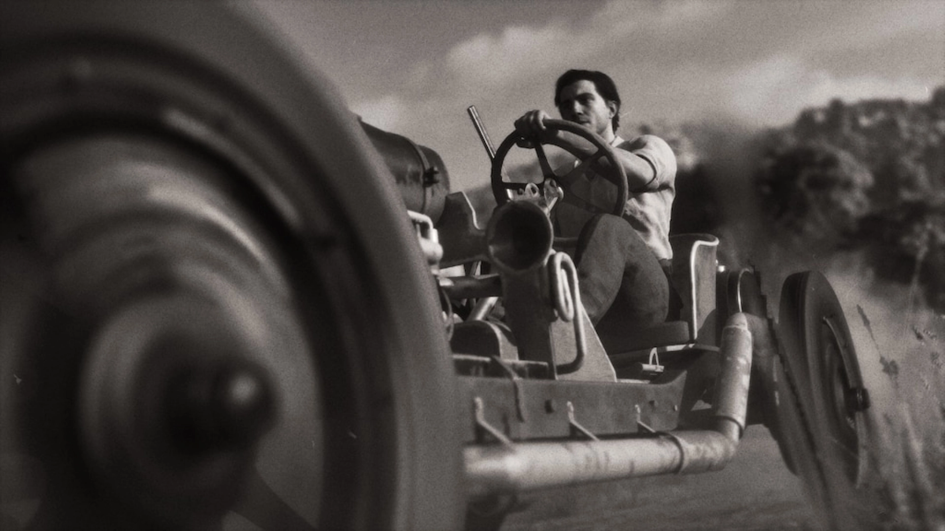 Man driving a vintage tractor in a black and white setting, capturing the essence of Valle Dorata