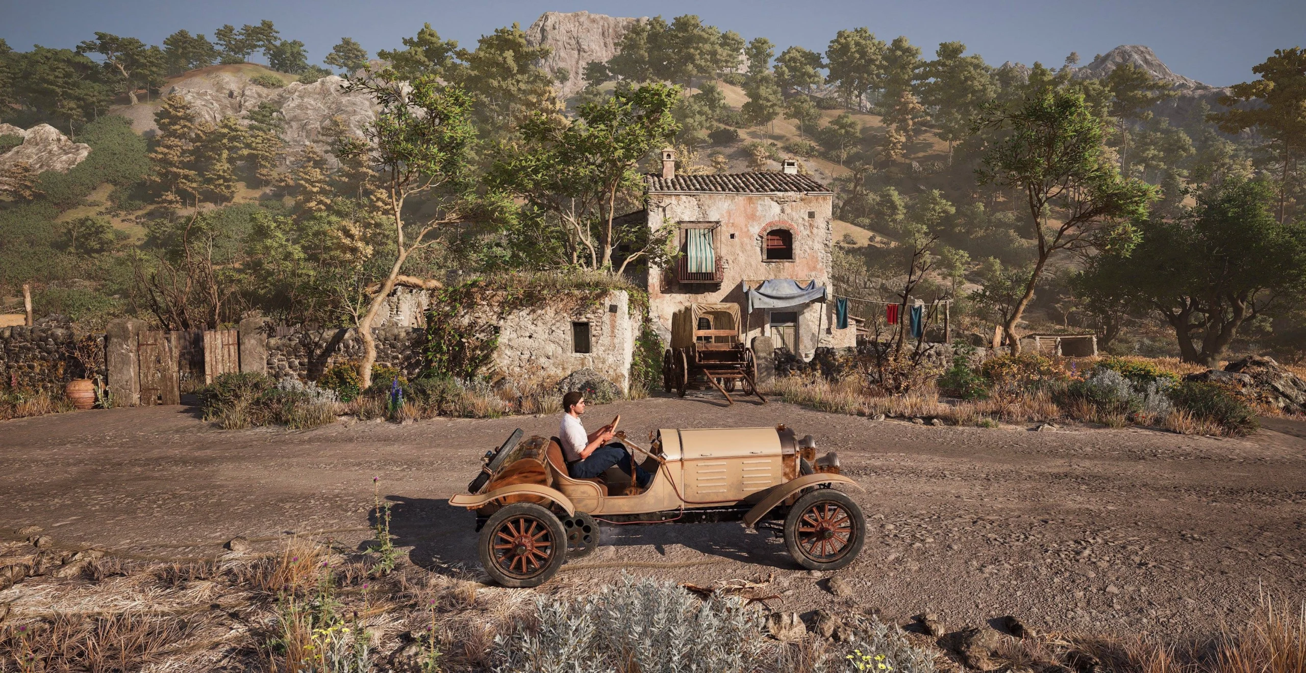 A vintage car drives past a rustic house surrounded by trees and hills in Valle Dorata, capturing nostalgia