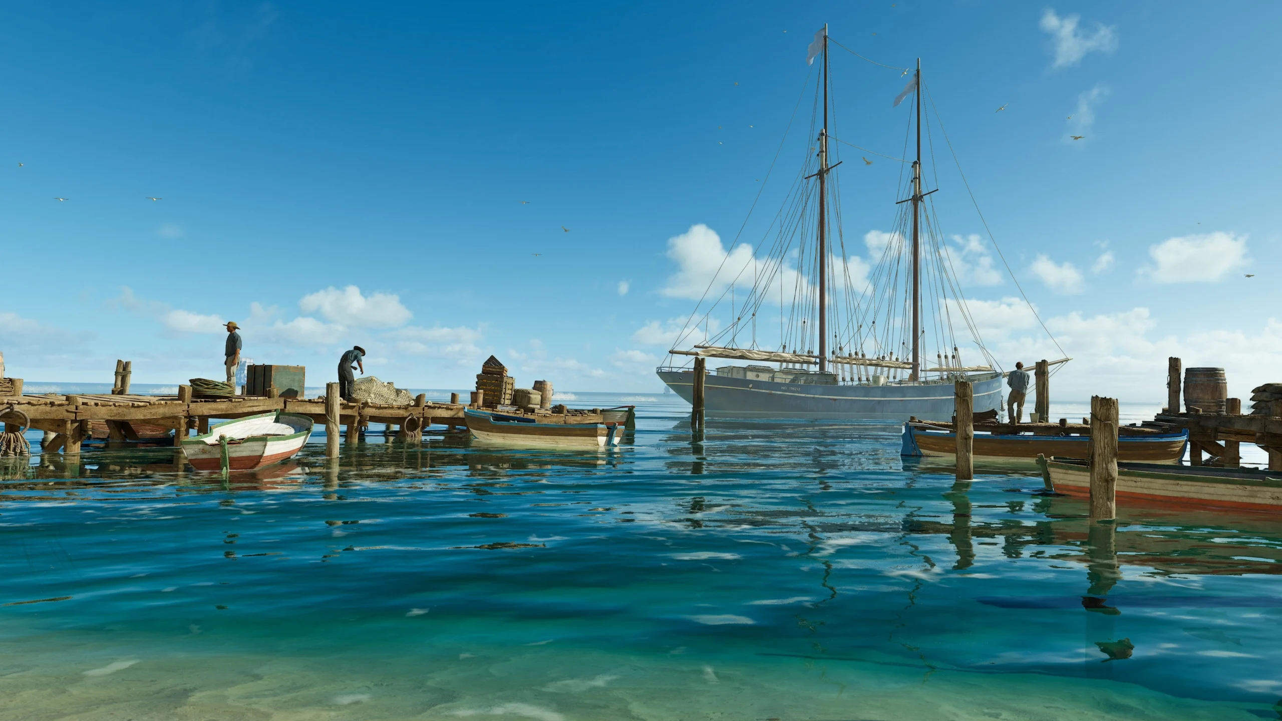 Sailboat docked at a wooden pier in Valle Dorata, clear blue sky and water reflecting the serene scene