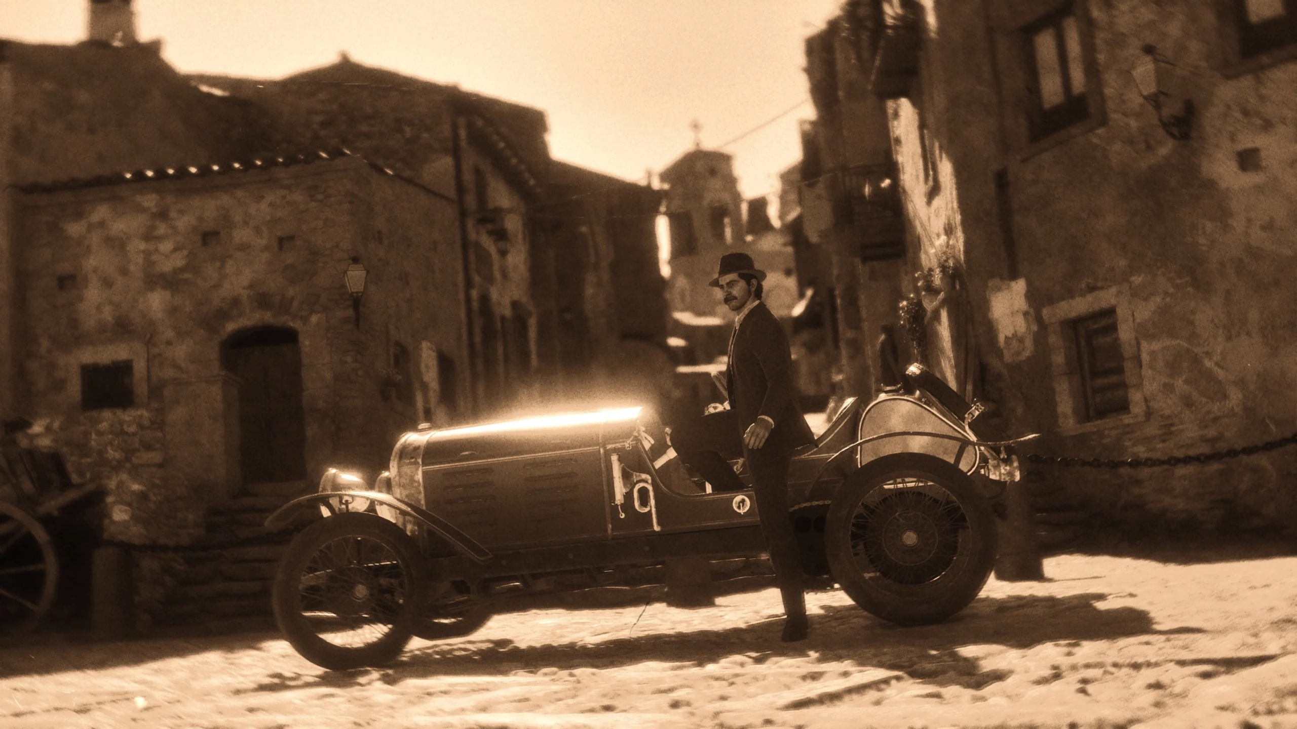 Vintage car parked on cobblestone street in Valle Dorata, capturing the nostalgic essence of Mafia: The Old Country