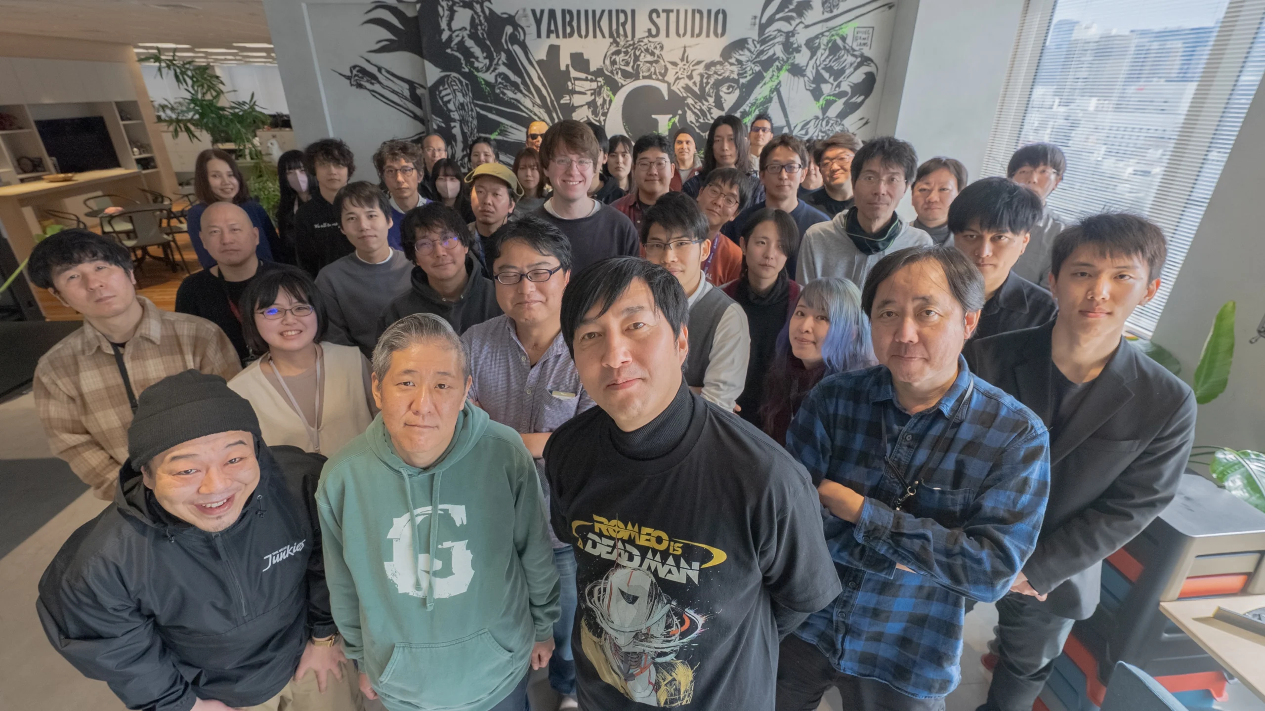 Group of game developers at Yabukiri Studio, including Goichi Suda and Ren Yamazaki, posing together