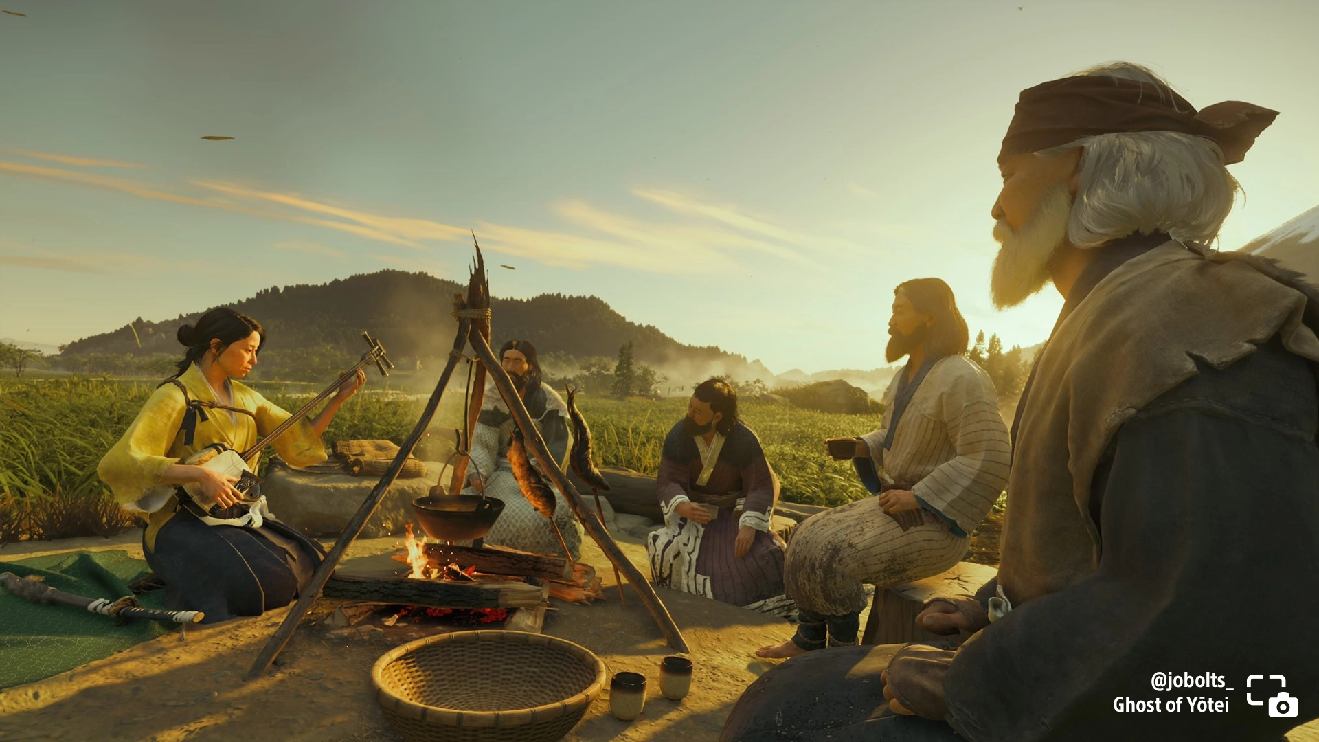 Atsu plays shamisen by a campfire with the Ainu tribe in Ghost of Yōtei, enjoying a rustic evening together