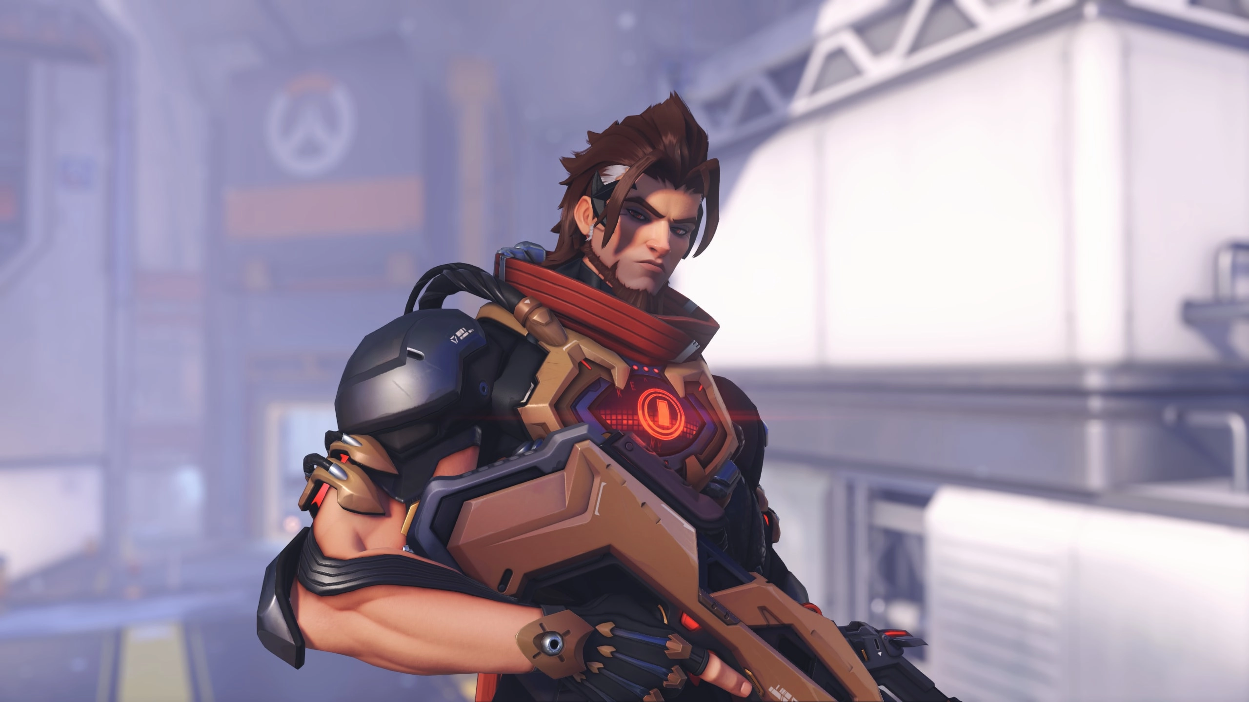 Hero character in futuristic armor holding a weapon, set in an Overwatch-themed environment