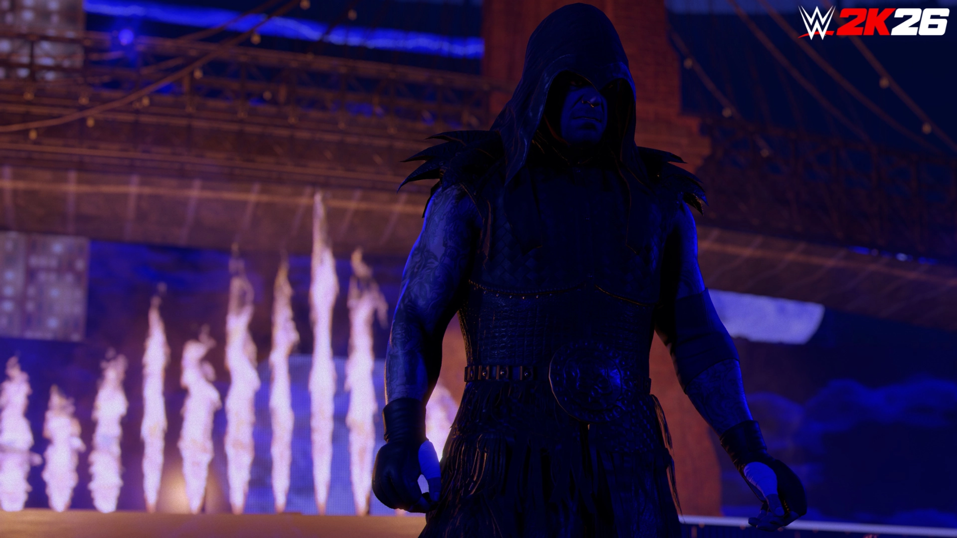 A mysterious wrestler in a dark hooded outfit stands in front of a fiery backdrop in WWE 2K26