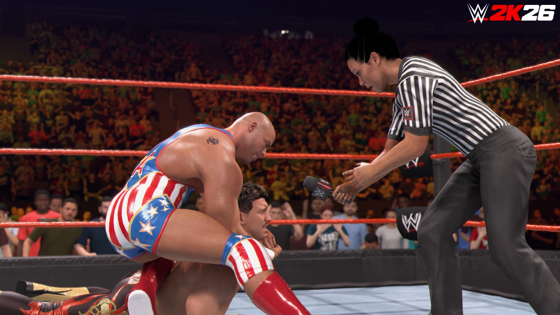 Wrestler in patriotic attire holds opponent in submission as referee offers microphone in WWE 2K26 ring