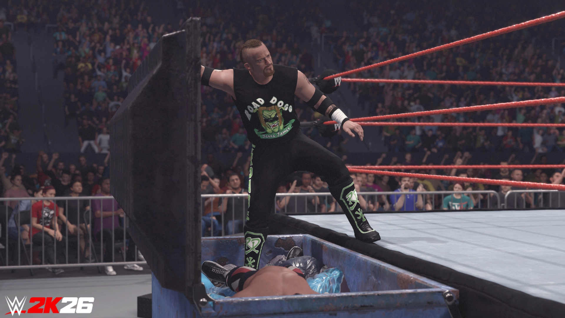 Wrestler in black attire stands over opponent in a casket during a WWE 2K26 match in a packed arena