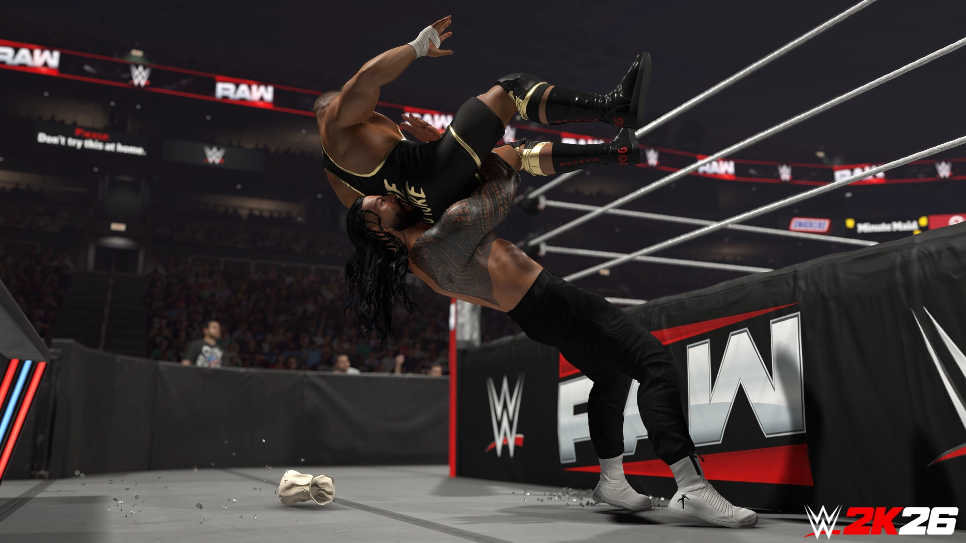 Wrestler performs a powerful suplex outside the ring in WWE 2K26, showcasing intense gameplay action